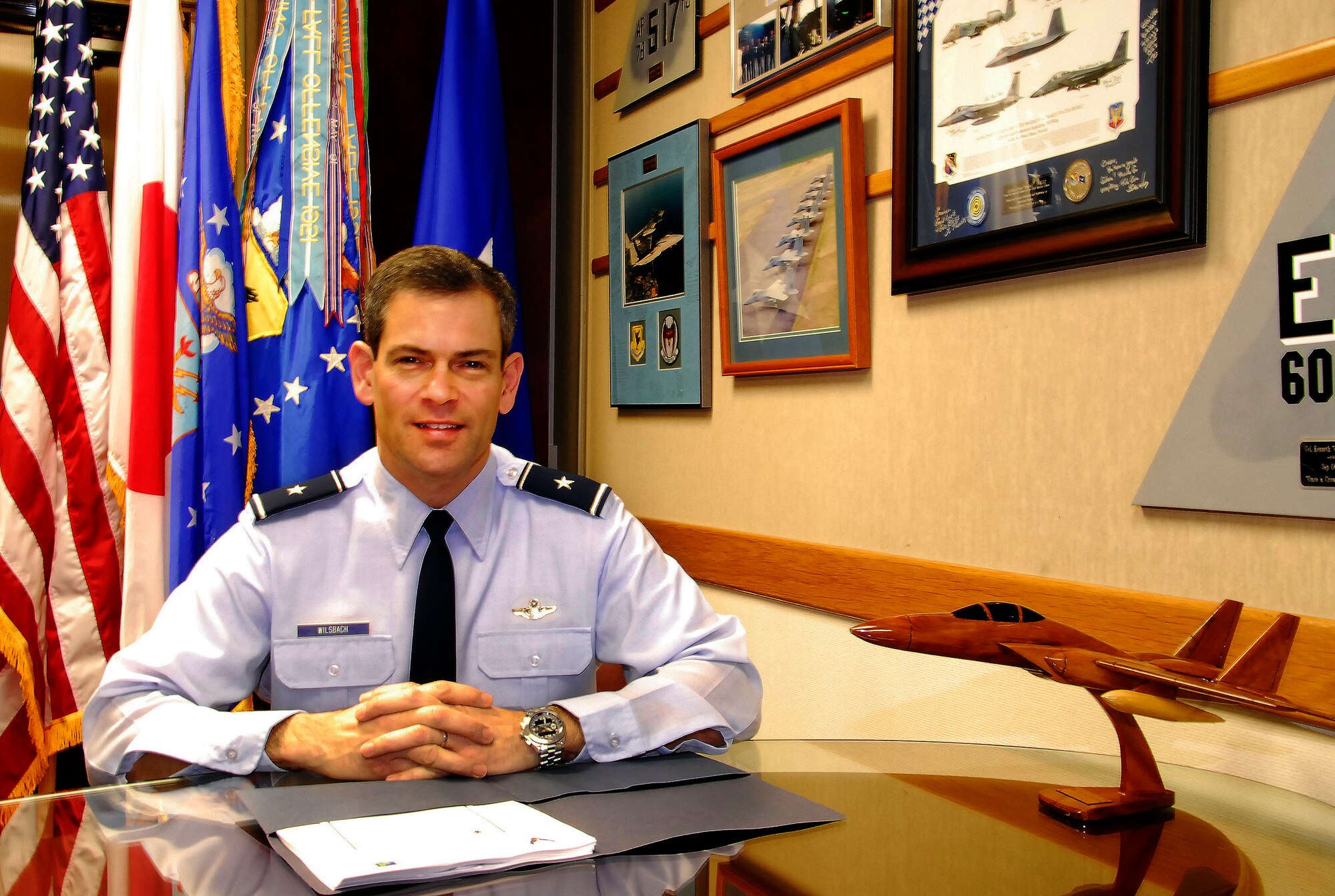Brig. Gen. Ken Wilsbach, 18th Wing commander, sits at a table in his office Jan. 10. General Wilsbach recently shared his goals and initiatives for the wing during 2011 with Airmen on-base, promoting cost savings, safety and strengthening relationships with the local community through good ambassadorship. (U.S. Air Force photo/ Airman 1st Class Maeson L. Elleman)