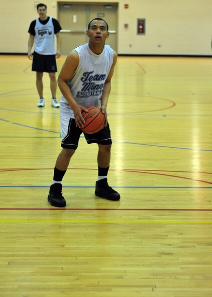 MINOT AIR FORCE BASE N.D. -- Airman 1st Class Tony Pecoraro, 91st Security Forces Group total response force member, prepares for a free throw during a basketball game at the McAdoo Fitness Center here Jan. 10. The 91st Operations Group defeated the 5th Mission Support Group 85 to 68. (U.S. Air Force photo/Senior Airman Michael J. Veloz)