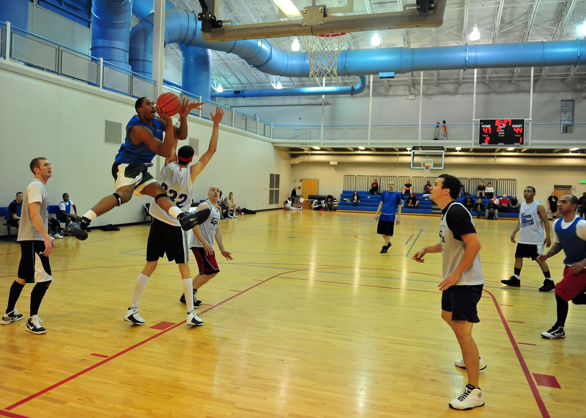 MINOT AIR FORCE BASE N.D. -- Senior Airman Victor Calcote, 5th Force Support Squadron chef, runs to the hoop for a layup during a basketball game at the McAdoo Fitness Center here Jan. 10. The 91st Operations Group defeated the 5th Mission Support Group 85 to 68. (U.S. Air Force photo/Senior Airman Michael J. Veloz)