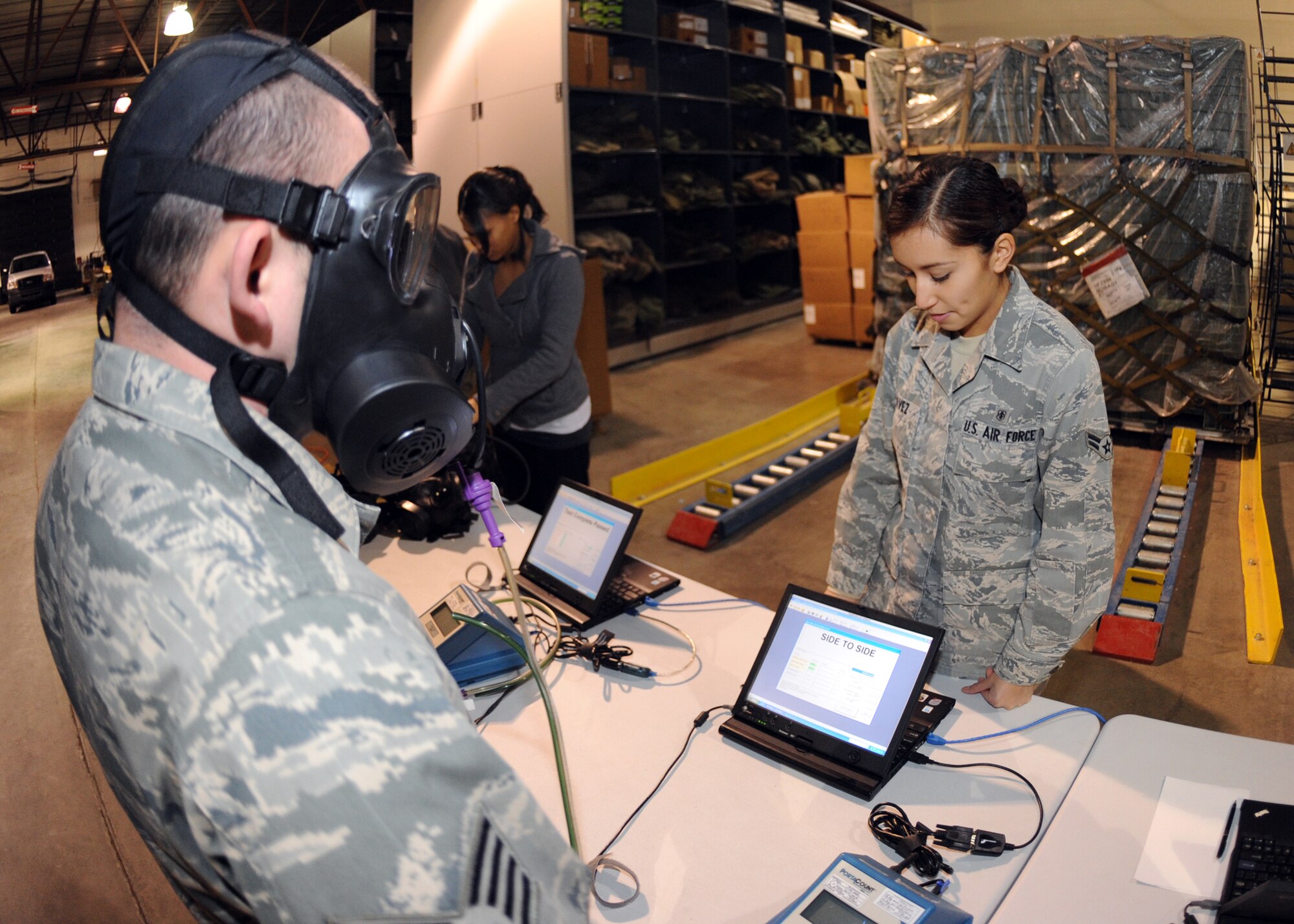 MINOT AIR FORCE BASE N.D. – Airman 1st Class Adile Chavez, 5th Medical Group dental technician, assists Staff Sgt. Timothy Styers, 5th Logistics Readiness Squadron fuels facilities supervisor, perform a mask seal test on the M-50 gas mask, here Jan 5. Minot Air Force Base is the first base in Air Force Global Strike Command to receive and issue the new M-50 gas mask. (Air force photo/Airman 1st Class Aaron-Forrest Wainwright)