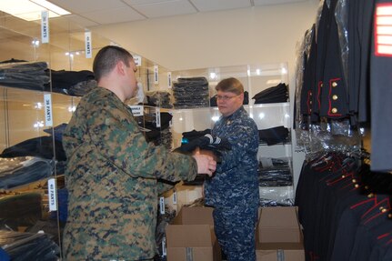 Hospital Corpsman 1st Class Steve Marsh, (left) checks over the uniform inventory with Hospital Corpsman Chief William Montague in the uniform shop of the Charles C. Carson Center for Mortuary Affairs. Both are enlisted morticians in the Navy. Marsh was here on a 30-day assignment from Quantico, Va. Montague is assigned to the mortuary as a liaison. (U.S. Air Force photo)