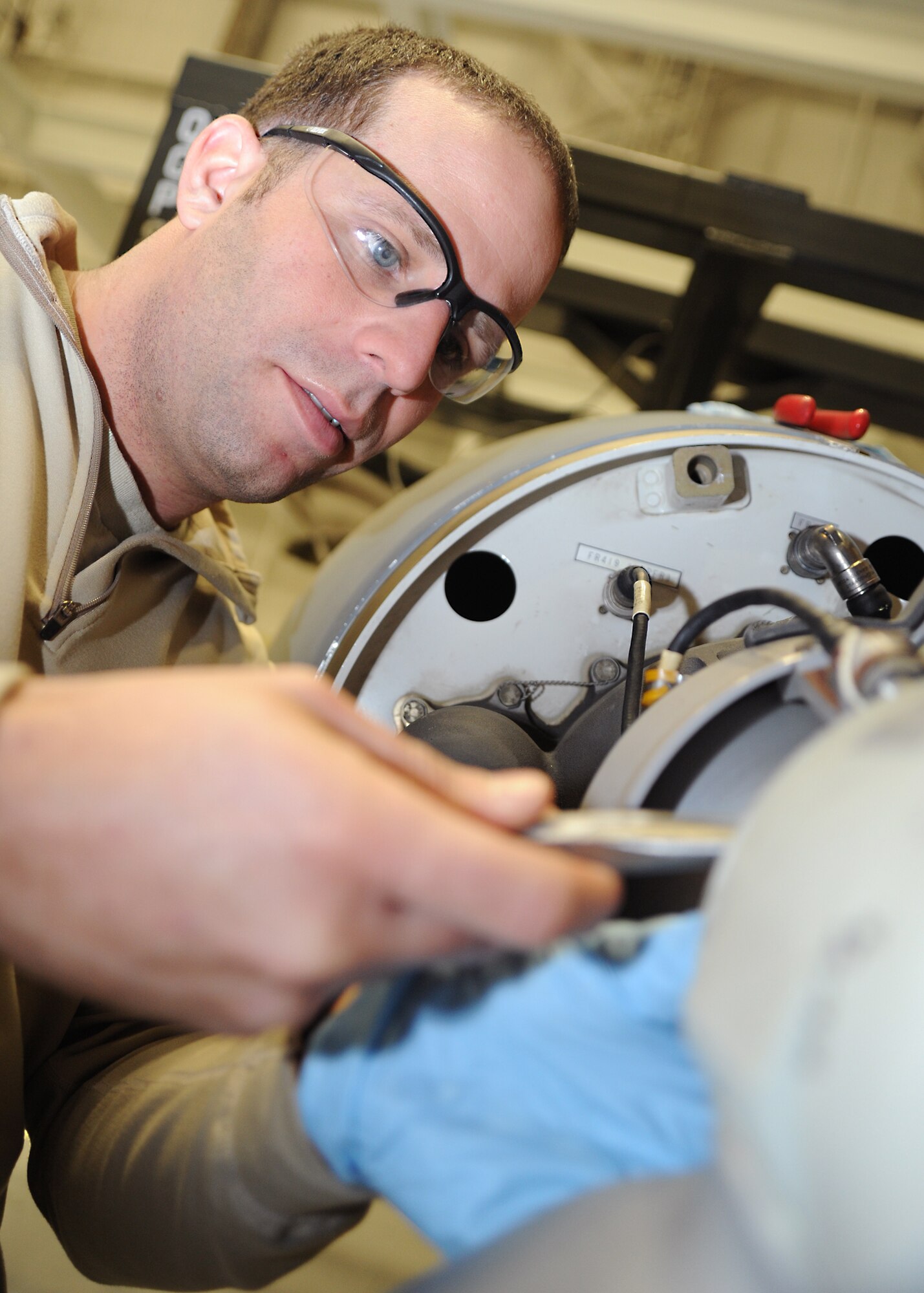 Senior Airman Giovanni Bosch, 22nd Aircraft Maintenance Squadron crew chief, wraps a safety wire on a bolt located on a mock training turbine for the KC-135 Stratotanker fuel pump January 10, 2011, McConnell Air Force Base, Kan.  The 373rd Training Squadron, Det. 8, trains maintenance Airmen in eight different Air Force Specialty Codes.  The 373rd TS currently has 18 instructors administered more than 19,000 teaching hours during 2010.  (U.S. Air Force photo/Senior Airman Maria A. Ruiz)