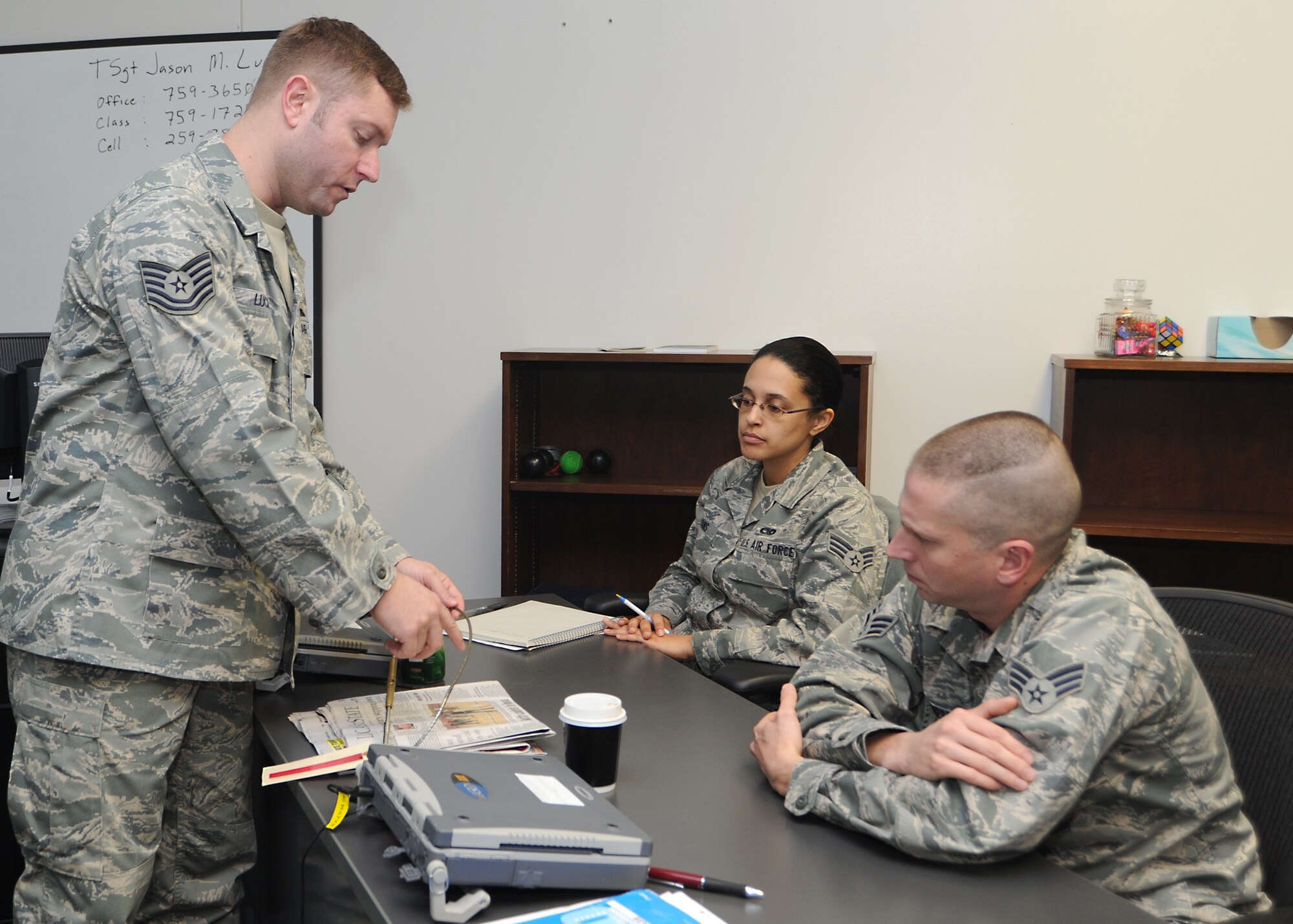 Tech. Sgt. Jason Lucius, 373rd Training Squadron, Det. 8, KC-135 Stratotanker aerospace repair instructor, demonstrates a frayed aircraft flight control cable to Senior Airmen Torre Evans and Arthur Thompson, 916th Maintenance Squadron crew chiefs, during an aerospace repair course January 10, 2011, McConnell Air Force Base, Kan. The 373rd TS provides Air Force active duty, guard and reserve members with advanced aircraft and aerospace ground equipment training. The 373rd TS is one of two tanker aircraft training squadrons located stateside. (U.S. Air Force photo/Senior Airman Maria A. Ruiz)