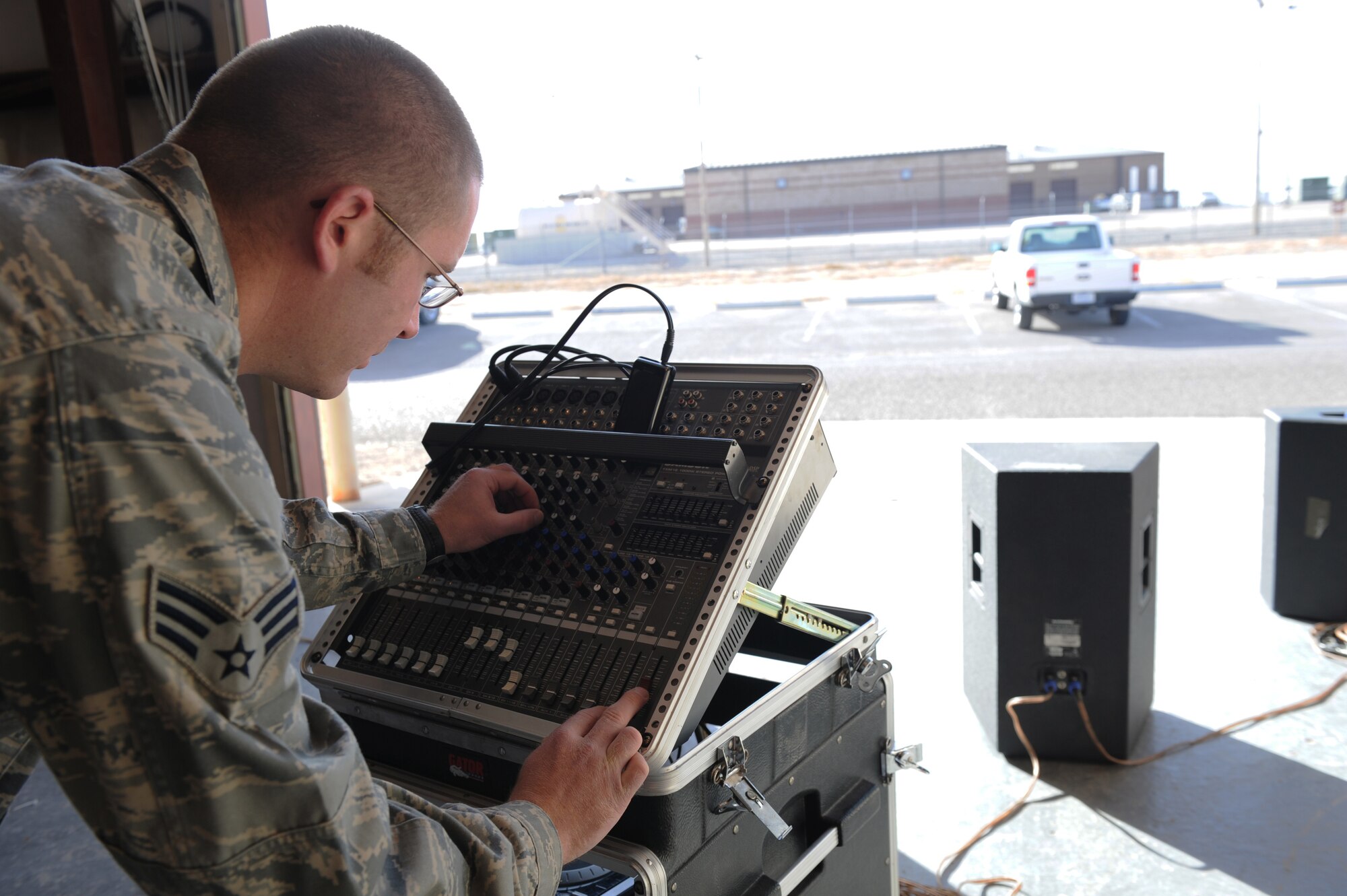 HOLLOMAN AIR FORCE BASE, N.M. -- Senior Airman Robert Linscott, 49th Communications Squadron, adjusts the audio on a mixer board during testing of the base public announcement system at the land mobile radio shop Jan. 7, 2011. Members of the 49th CS are responsible for maintaining the base's public announcement system, also known as the "giant voice." (U.S. Air Force photo by Airman 1st Class Eileen Payne/Released)