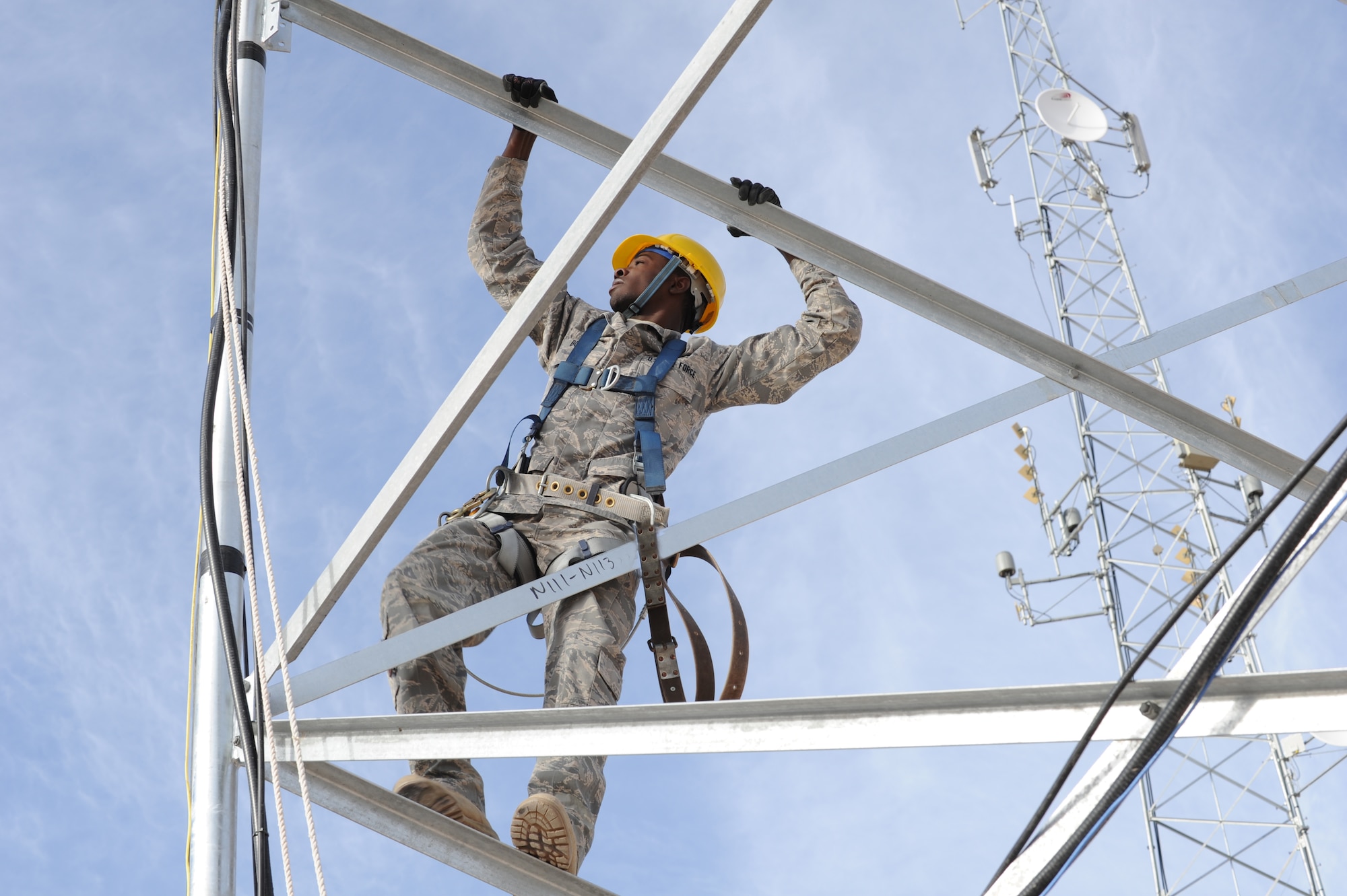 HOLLOMAN AIR FORCE BASE, N.M. -- Airman 1st Class Justin Bowden, 49th Communications Squadron, climbs a radio tower at the land mobile radio shop Jan. 7, 2011, to align a point-to-point shot, connecting the base's Network Control Centers. The radio tower also serves as a back-up satellite if the base should lose connectivity to the internet. (U.S. Air Force photo by Airman 1st Class Eileen Payne/Released)