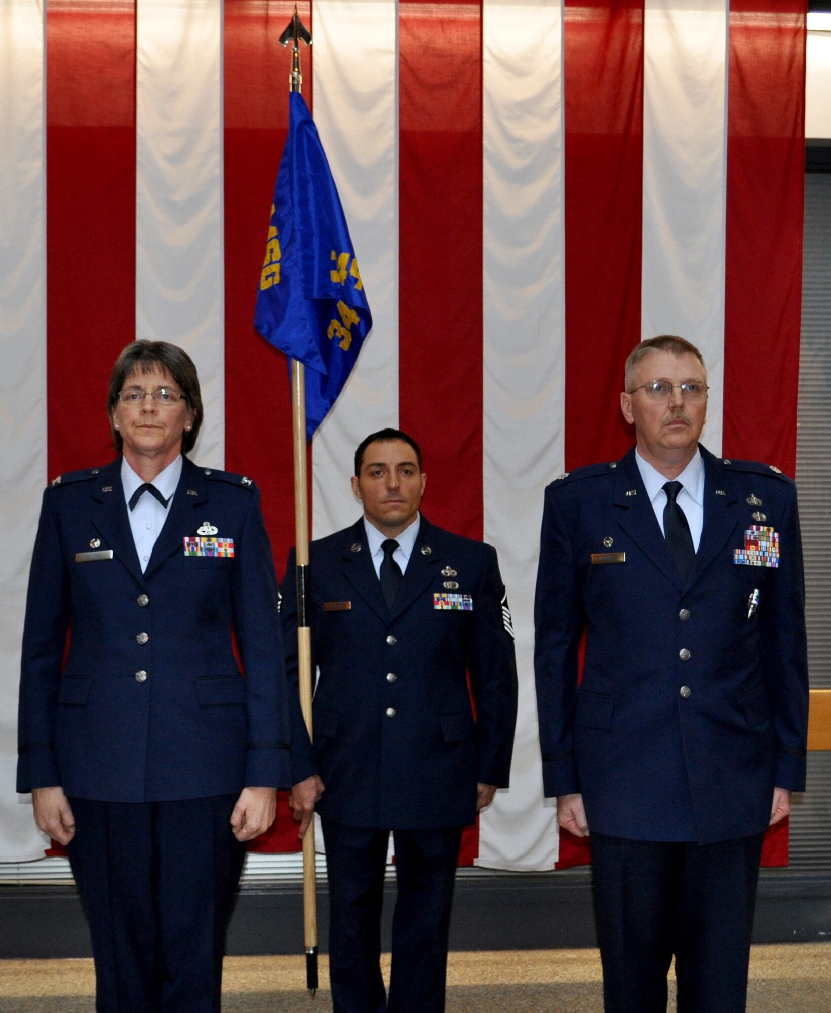 TRAVIS AIR FORCE BASE, Calif. -- Col. Nancy Brooks, commander, 349th Mission Support Group, Lt. Col. Neal Landeen, commander, Force Support Squadron,  and Master Sgt.  Mark Eger, first sergeant, Force Support Group, stand at attention prior to the inactivation of the 349th Mission Support Squadron during a redesignation ceremony held here on January 8, 2011. (U.S. Air Force photo/Senior Airman Amelia Leonard)