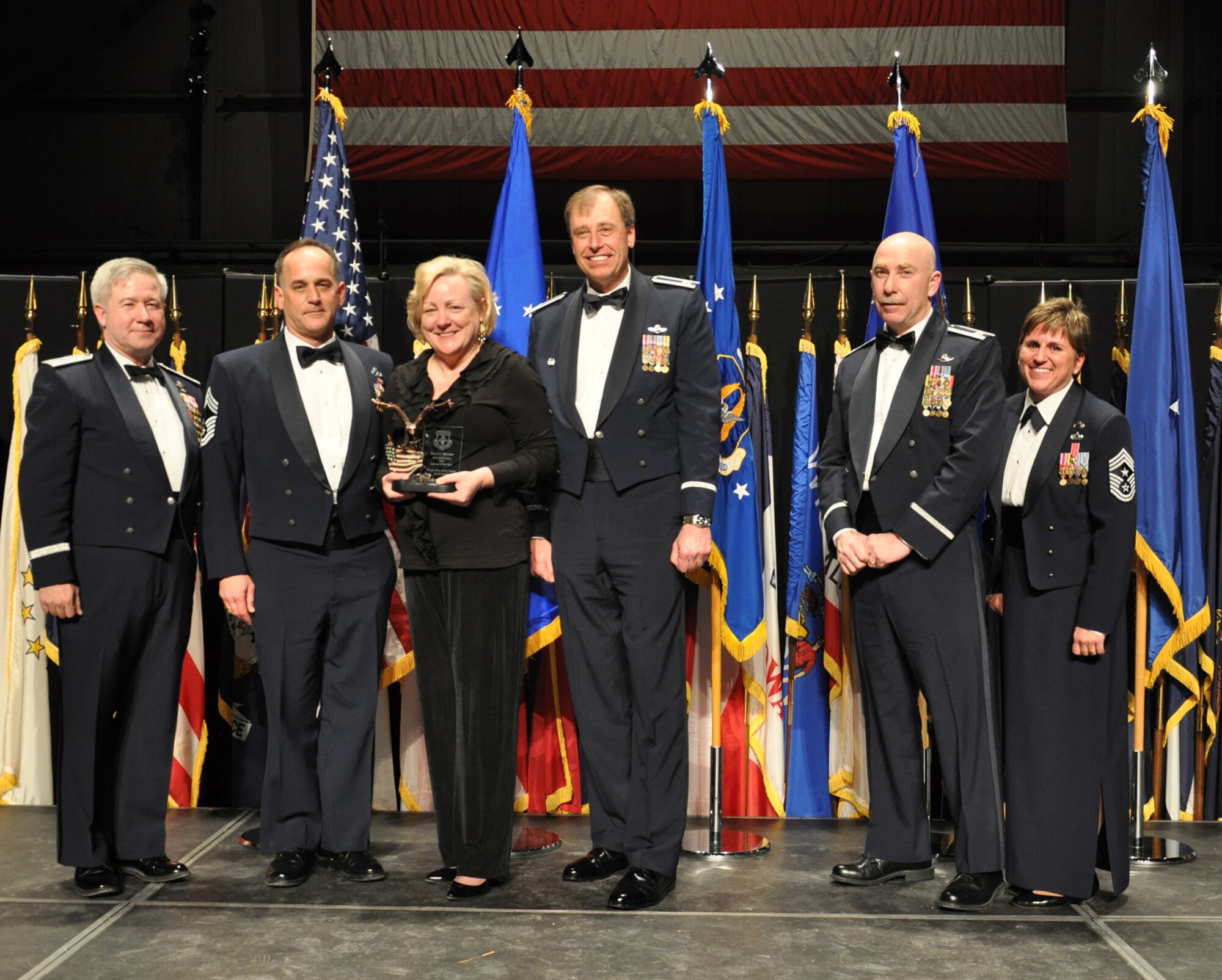 WRIGHT-PATTERSON AIR FORCE BASE, Ohio – From left to right; Brig. Gen. Keith Kries, mobilization assistant to the 8th Air Force commander, and commander of the Joint Functional Component Command for global strike, U.S. Strategic Command; Chief Master Sgt. Aaron Mouser, 445th Maintenance Group; his wife, Mrs. Sally Mouser; Col. Stephen Goeman, 445th Airlift Wing commander; Col. Steven Johnson, 445th Airlift Wing vice commander; and Chief Master Sgt. Peri Rogowski, 445th Airlift Wing command chief.  Mrs. Mouser was selected as the 445 AW Spouse of the Year at the 445 AW Annual Awards Banquet Jan. 8.  (U.S. Air Force photo/Senior Airman Mikhail Berlin)