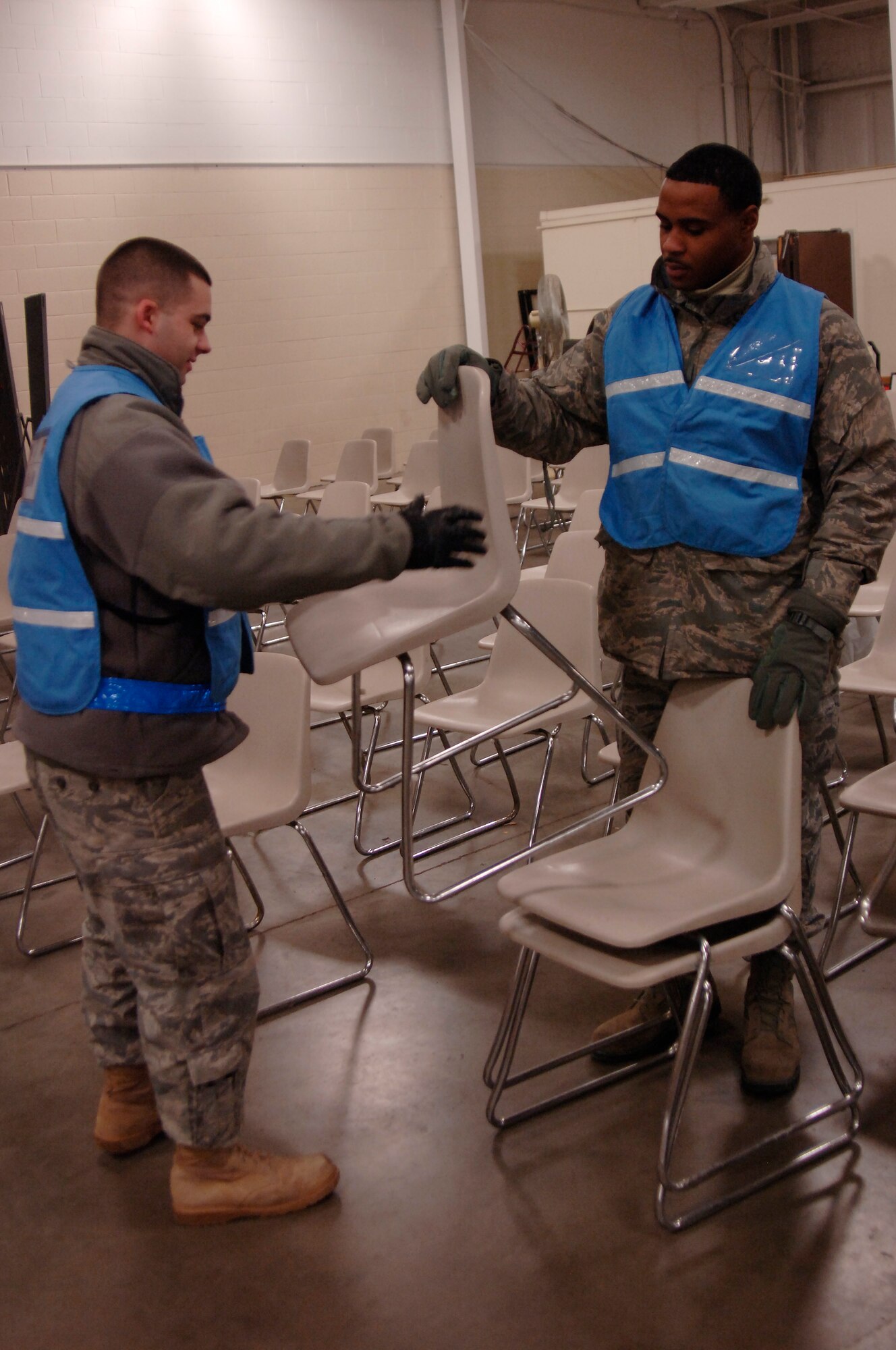 Senior Airmen Sheldon Ricks and Thomas Maynard, both with the 375th Logistics Readiness Squadron, setup chairs for the more than 200 Airmen that will process through the mobility line as part of an exercise, Jan. 12, 2011 at Scott Air Force Base, Ill. Mobility exercises are held to ensure that every member of Team Scott stands ready to deploy at a moments notice. (U.S. Air Force photo/ Senior Airman Wesley Farnsworth)