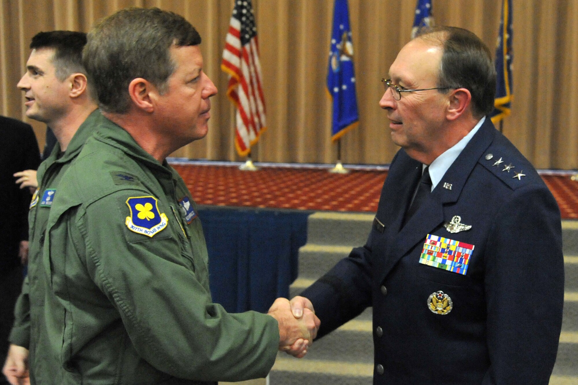 Lt. Gen. Charles E. Stenner Jr., commander of the Air Force Reserve Command, speaks with Col. Keith Schultz, commander, 307th Operations Group, after reactivation ceremonies for the 307th Bomb Wing at Barksdale Air Force Base, La., Jan. 8, 2011. Colonel Schultz is wearing the new 307th BW patch on his shoulder. As for the historic meaning of the original design, ultramarine blue is the color of the Air Forces. The four petals of the dog wood stands for the four combat squadrons of the group with the stem representing the headquarters binding the four groups together. During the same ceremonies, the 917th Operations Group was re-designated as the 917th Fighter Group and the 917th Wing was deactivated. (U.S. Air Force photo/Staff Sgt. Travis Robertson)