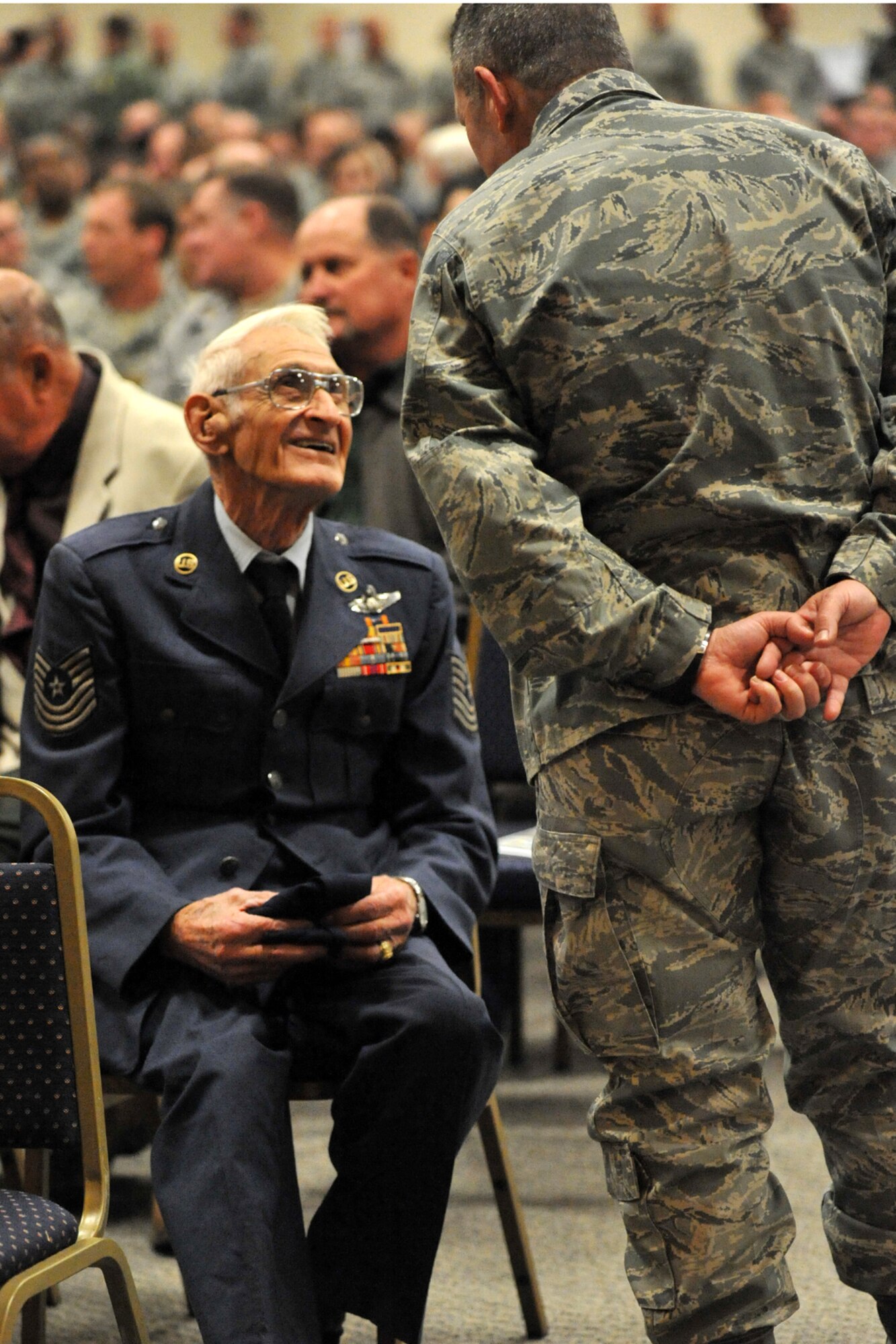 A present day 307th Bomb Wing Airman speaks with Master Sgt. (Ret) Loren T. Longman, a 307th BW alumni before the reactivation ceremonies for the 307th BW at Barksdale Air Force Base, La., Jan. 8, 2011. Sergeant Longman is a World War II and Korean War veteran who served in the 307th BW from 1947-55. During the same ceremonies, the 917th Wing was deactivated and the 917th Operations Group was re-designated as the 917th Fighter Group. (U.S. Air Force photo/Staff Sgt. Travis Robertson)