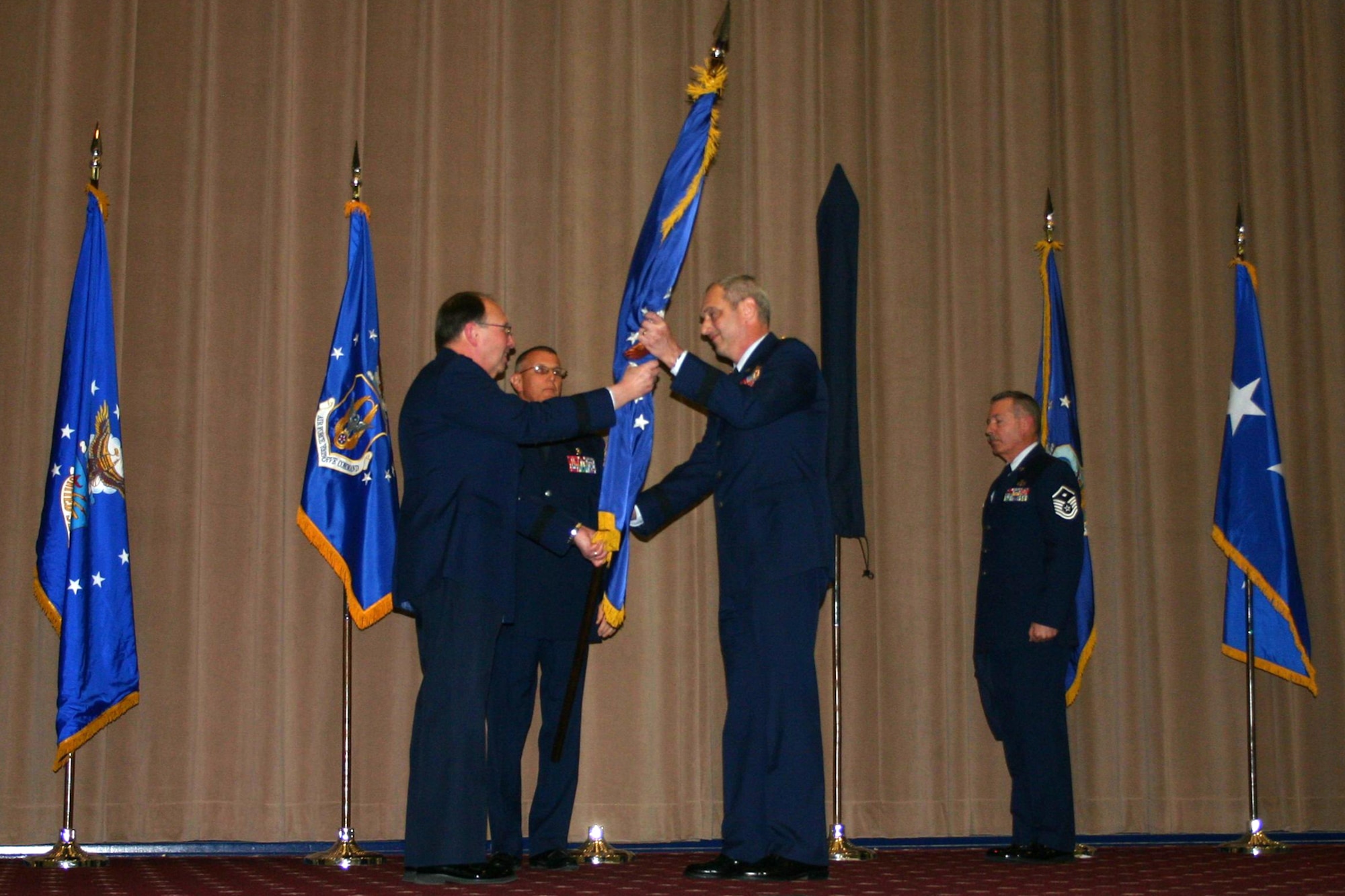 Lt. Gen. Charles E. Stenner Jr., commander of the Air Force Reserve Command, presents the 307th Bomb Wing flag to Brig. Gen. John J. Mooney III, during reactivation ceremonies at Barksdale Air Force Base, La., Jan. 8, 2011. During the same ceremonies, the 917th Operations Group was re-designated as the 917th Fighter Group and the 917th Wing was deactivated. (U.S. Air Force photo/Staff Sgt. Travis Robertson)