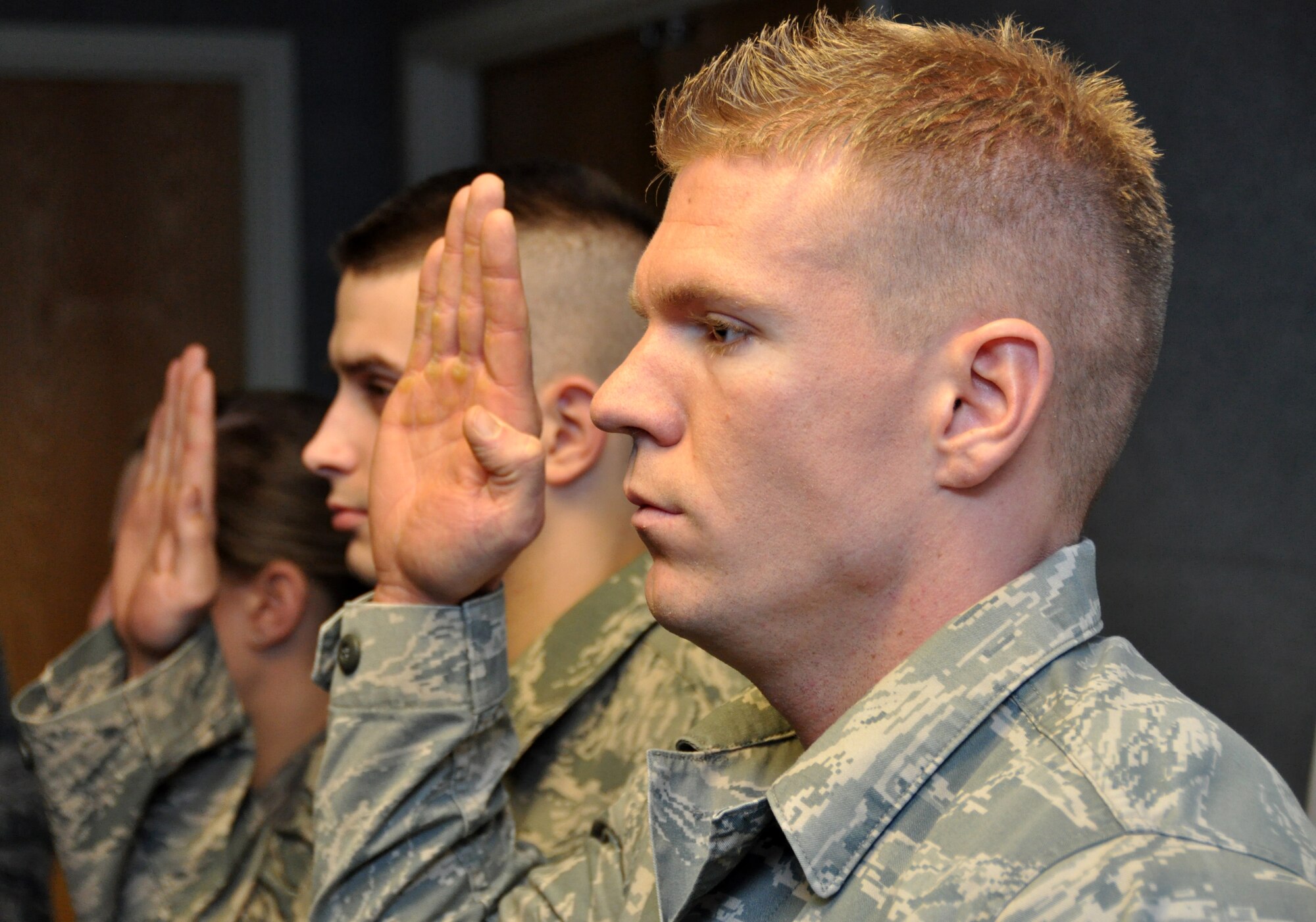 Staff Sgt. Zachary Stevens, 419th Security Forces Squadron, holds up his right hand as the NCO Creed is read. Sergeant Stevens was one of three Airmen promoted to staff sergeant at the 419th Fighter Wing’s promotion ceremony Jan. 9. (U.S. Air Force photo/Staff Sgt. Richard Gonzales)