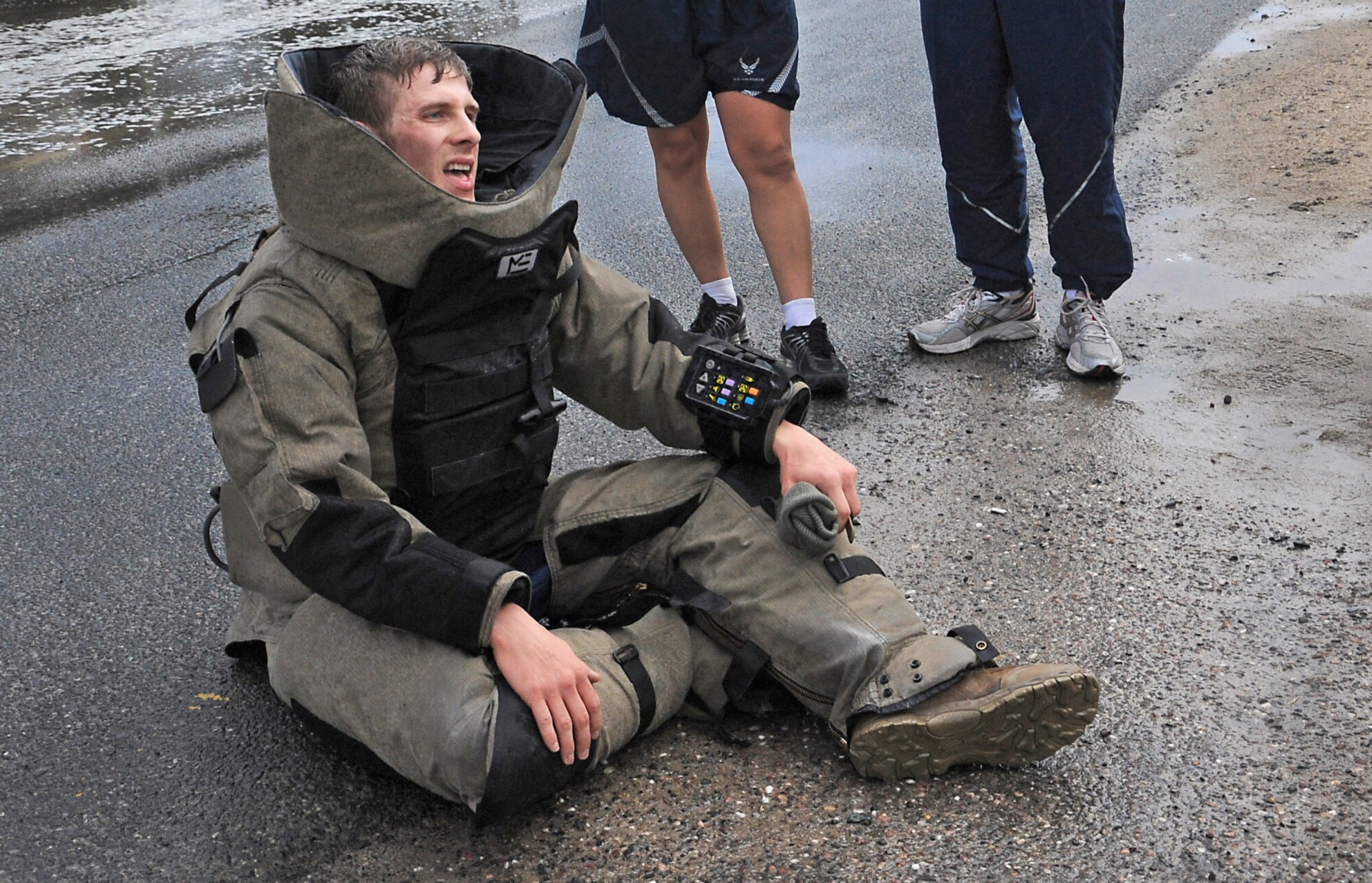Staff Sgt. Robin Cunningham rests in his bomb suit after participating in the explosive ordnance disposal fun run Dec. 31, 2010, at a base in Southwest Asia. Sergeant Cunningham is an EOD journeyman with the 386th Expeditionary Civil Engineer Squadron. (U.S. Air Force photo/Senior Airman Cynthia Spalding)
