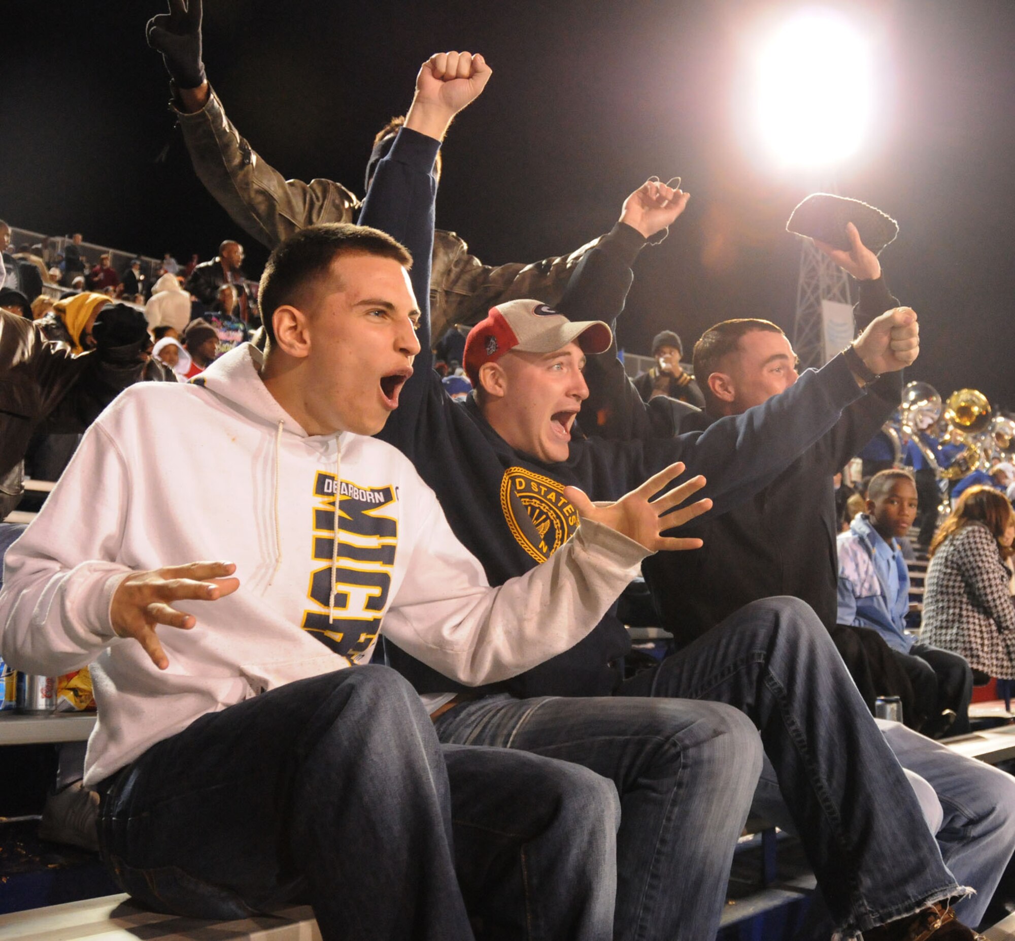 From left, Jordan Sepetys, Shawn Smith and Nick Nodine, Keesler Center for Naval Aviation Technical Training Unit students, cheer for Middle Tennessee State University at the Go Daddy Bowl Jan. 6 in Mobile, Ala. The Blue Raiders lost to the Miami (Ohio) Redhawks, 35-21.  (U.S. Air Force photo by Kemberly Groue)