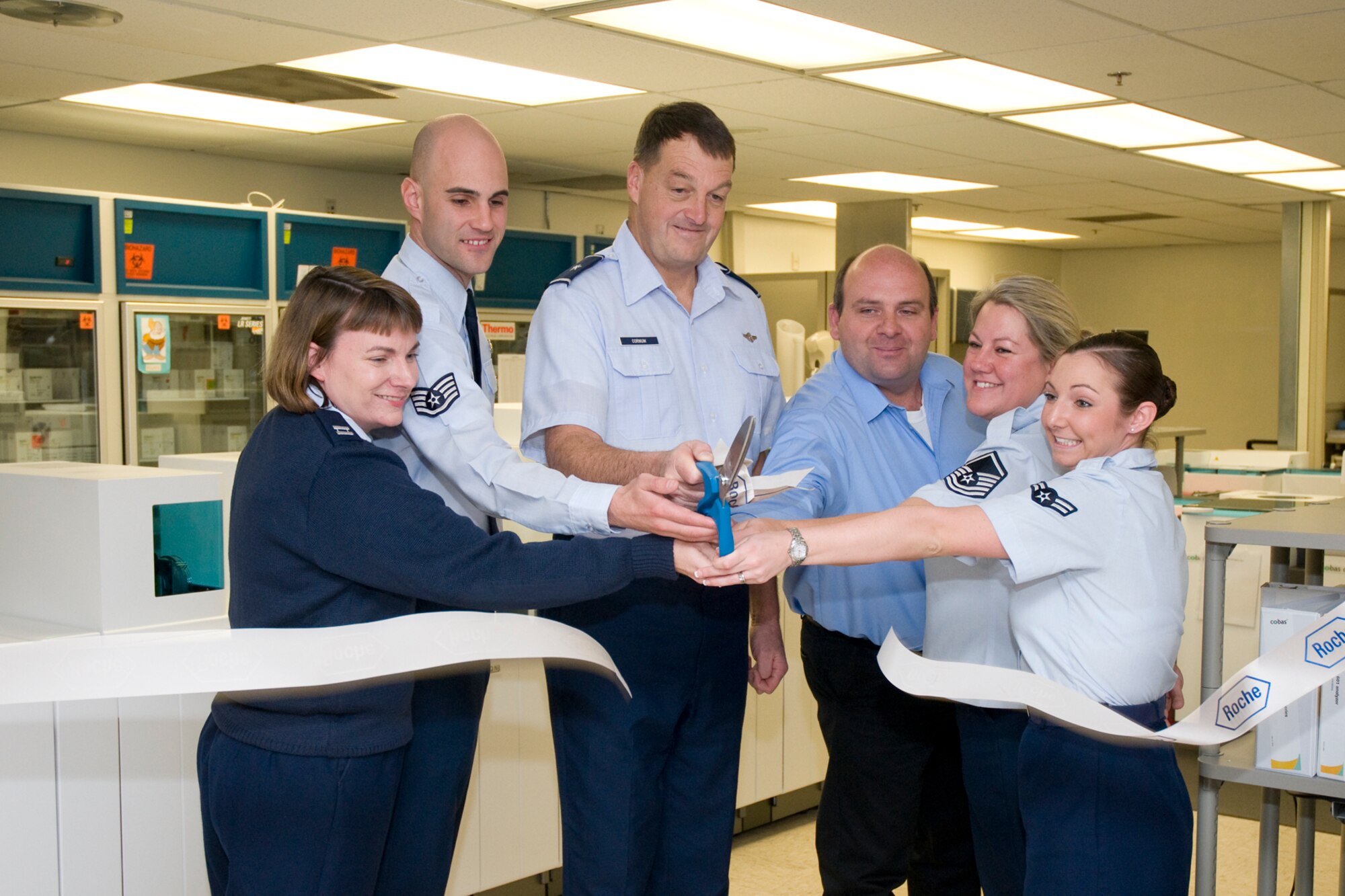 Brig. Gen. Kory Cornum, center, 81st Medical Group commander, joins members of the lab staff as they cut the ribbon marking the formal dedication of the core lab’s new analyzers Dec. 20.  From left are Captain Caldwell, Staff Sgt. Zachary Derringer, Jimmy Collins, Master Sgt. Karen Jenkins and Airman 1st Class Rebekah Colon.  (U.S. Air Force photo by Adam Bond)