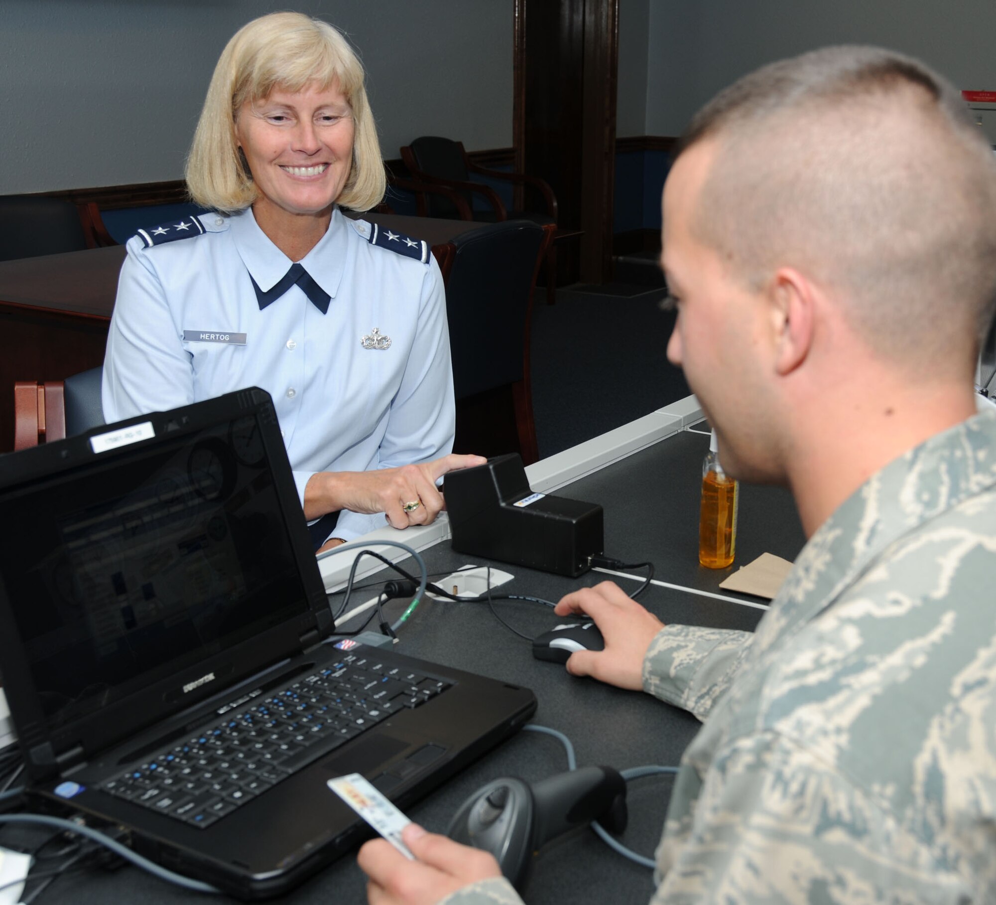 Maj. Gen. Mary Kay Hertog, 2nd Air Force commander, is registered for the new Defense Biometric Identification System by Staff Sgt. Kurt Rodriguez, 81st Security Forces Squadron. Registration takes five minutes and involves scanning an ID card’s barcode, verifying information and taking an electronic fingerprint. Registration for active-duty members and Defense Department employees runs through March 31. Registration for retirees and dependants is April 1 through June 31, but the pass and ID office won’t turn away those wishing to register earlier. Registration sites include the visitor center across from theWhite Avenue Gate, the military personnel section in Sablich Center, the exchange pharmacy and the 81st Medical Group Hospital’s information desk. For more information, call 377-3844.  (U.S. Air Force photo by Kemberly Groue)