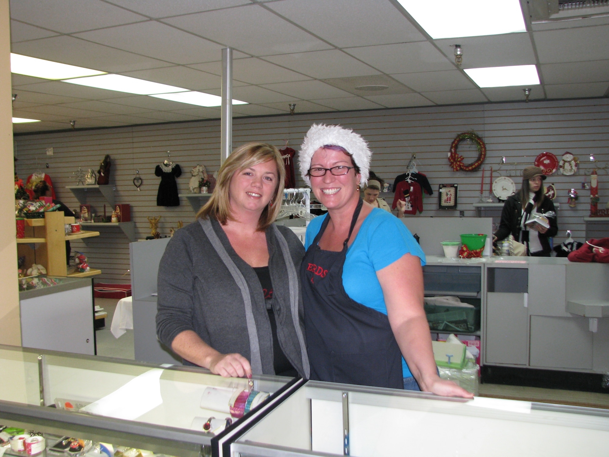 Michele Spencer (left) takes over the management role for the Edwards Thrift Shop from past manager, Stephanie Grafel as the Grafels' tour at Edwards winds down. (Air Force photo by Diane Betzler)