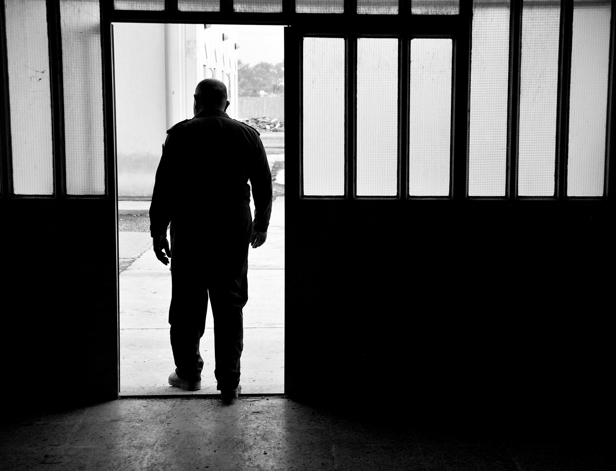 The Iraqi Air Force Training School's commandant walks outside after a meeting with air advisors from the 821st Expeditionary Training Squadron Dec. 13, 2010, in Taji, Iraq. Airmen with the 821st ETRS work daily with the faculty and students at the school to help it become an enduring and self sufficient training pipeline for the Iraqi air force and Ministry of Defense. (U.S. Air Force photo/Senior Airman Andrew Lee)