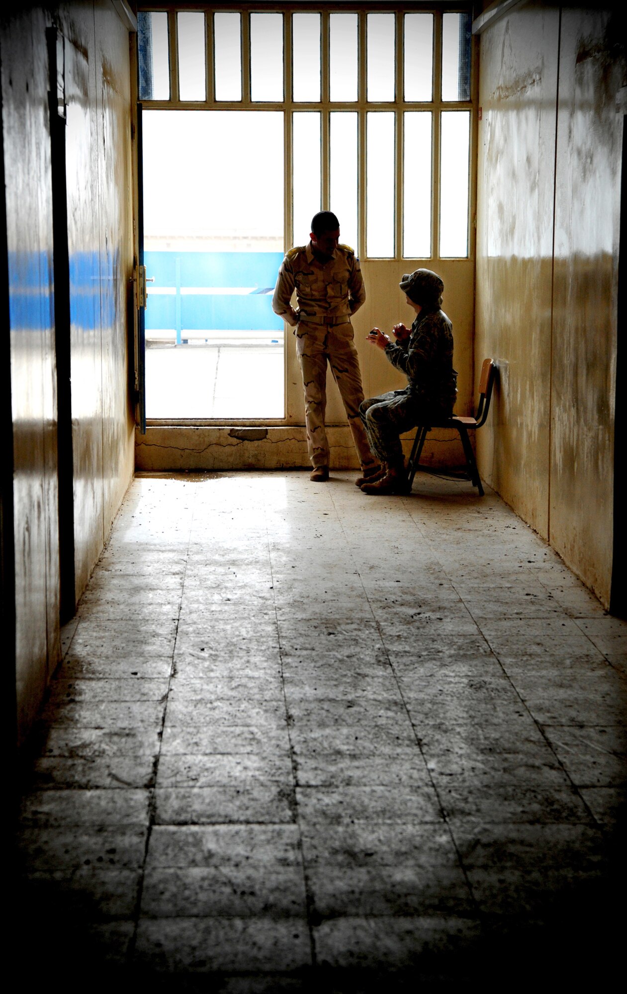 Lt. Col. Christopher Finta talks with an Iraqi airman in the hallway of the Iraqi Air Force Training School Dec. 13, 2010, in Taji, Iraq. Airmen with the 821st ETRS work daily with the faculty and students at the school to help it become an enduring and self-sufficient training pipeline for the Iraqi air force and Ministry of Defense. Colonel Finta is the 821st Expeditionary Training Squadron director of operations. (U.S. Air Force photo/Senior Airman Andrew Lee) 