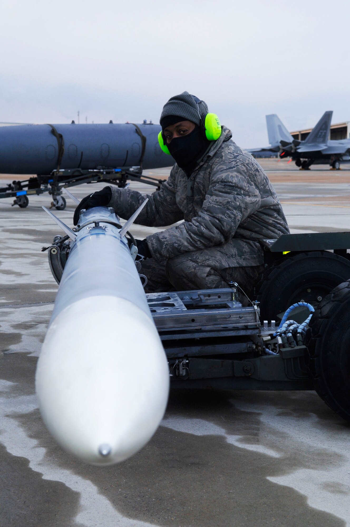 LANGLEY AIR FORCE BASE, Va - Staff Sgt. Lamont Brown, 1st Maintenance Squadron weapons load crew chief, waits for the command to load munitions onto an aircraft during an Operational Readiness Exercise Jan. 8. The 1st Fighter Wing, 633d Air Base Wing and 192d Fighter Wing tested the Wings’ readiness if faced with a disaster, imminent terrorist or enemy threat or short-notice orders to deploy.  (U.S. Air Force photo/Staff Sgt. Ashley Hawkins)(RELEASED)
