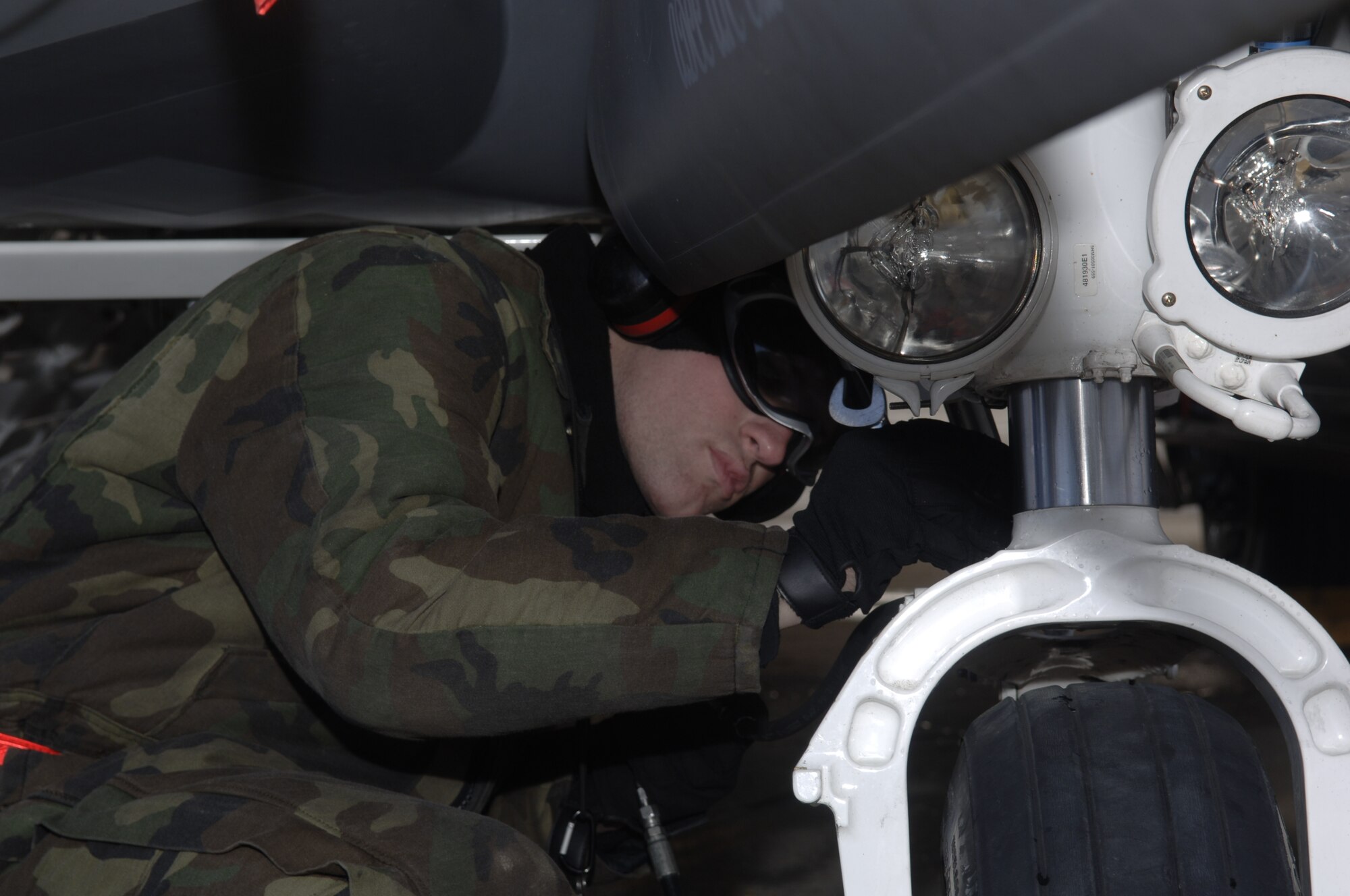 LANGLEY AIR FORCE BASE, Va - Senior Airman Richard McClane, 1st Maintenance Squadron weapons load crew chief, fixes an aircraft's flat tire during an Operational Readiness Exercise Jan. 8. The 1st Fighter Wing, 633d Air Base Wing and 192d Fighter Wing tested the Wings’ readiness if faced with a disaster, imminent terrorist or enemy threat or short-notice orders to deploy. (U.S. Air Force photo/Staff Sgt. Ashley Hawkins)(RELEASED)