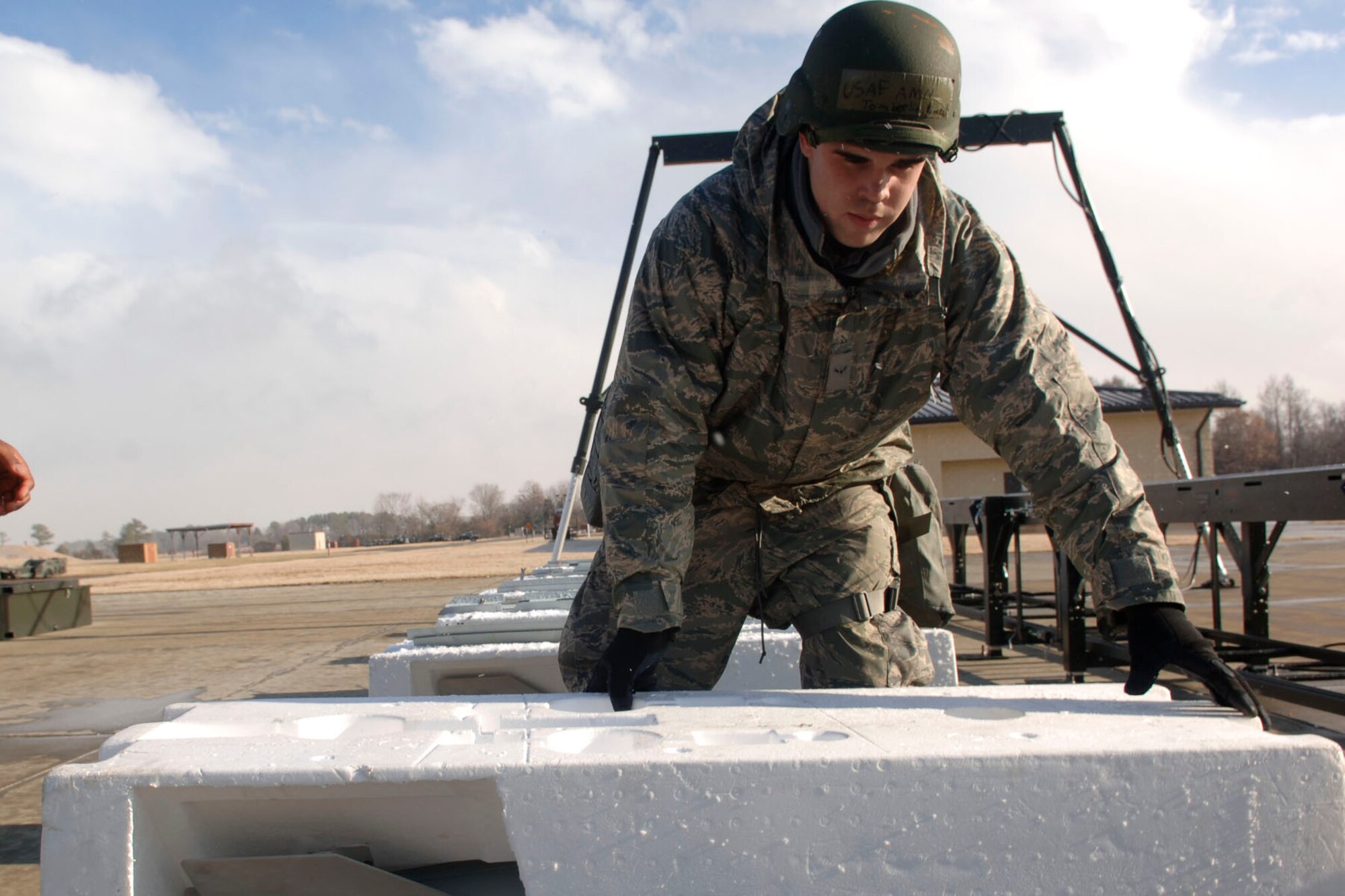 LANGLEY AIR FORCE BASE, Va - Airman 1st Class Vincent Tomberlin, 1st Maintenance Squadron weapons loader, handles munitions ready for transport to an aircraft during  an Operational Readiness Exercise Jan. 8. The 1st Fighter Wing, 633d Air Base Wing and 192d Fighter Wing tested the Wings’ readiness if faced with a disaster, imminent terrorist or enemy threat or short-notice orders to deploy. (U.S. Air Force photo/Staff Sgt. Ashley Hawkins)(RELEASED)