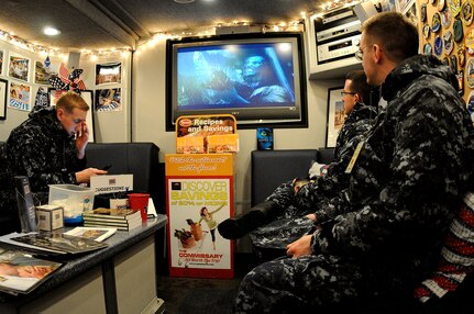 Sailors from the Naval Nuclear Power Training Command on Joint Base Charleston-Weapons Station, escape the blistering cold weather and enjoy free refreshments while watching the movie "Avatar" inside the USO mobile unit, Jan. 10. The East Coast USO mobile unit visited the Charleston area, providing a relaxing atmosphere and entertainment for Sailors. (U.S. Navy photo/Mass Communication Specialist 1st Class Jennifer R. Hudson)