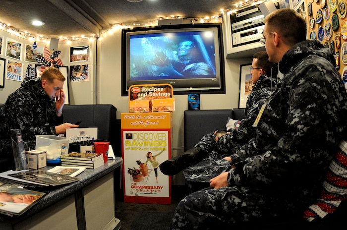 Sailors from the Naval Nuclear Power Training Command on Joint Base Charleston-Weapons Station, escape the blistering cold weather and enjoy free refreshments while watching the movie "Avatar" inside the USO mobile unit, Jan. 10. The East Coast USO mobile unit visited the Charleston area, providing a relaxing atmosphere and entertainment for Sailors. (U.S. Navy photo/Mass Communication Specialist 1st Class Jennifer R. Hudson)