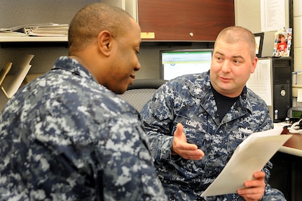 Navy Personnel Specialist 1st Class James Long Jr. mentors Personnel Specialist 2nd Class Charles Tobler on his advancement profile sheet, giving some much needed advice on how to advance to Petty Officer First class for the 2011 March exam. PS1 Long was selected as the Naval Support Activity Sailor of the year for 2011 for Joint Base Charleston-Weapons Station. (U.S. Navy photo/Machinist’s Mate 3rd Class Brannon Deugan)