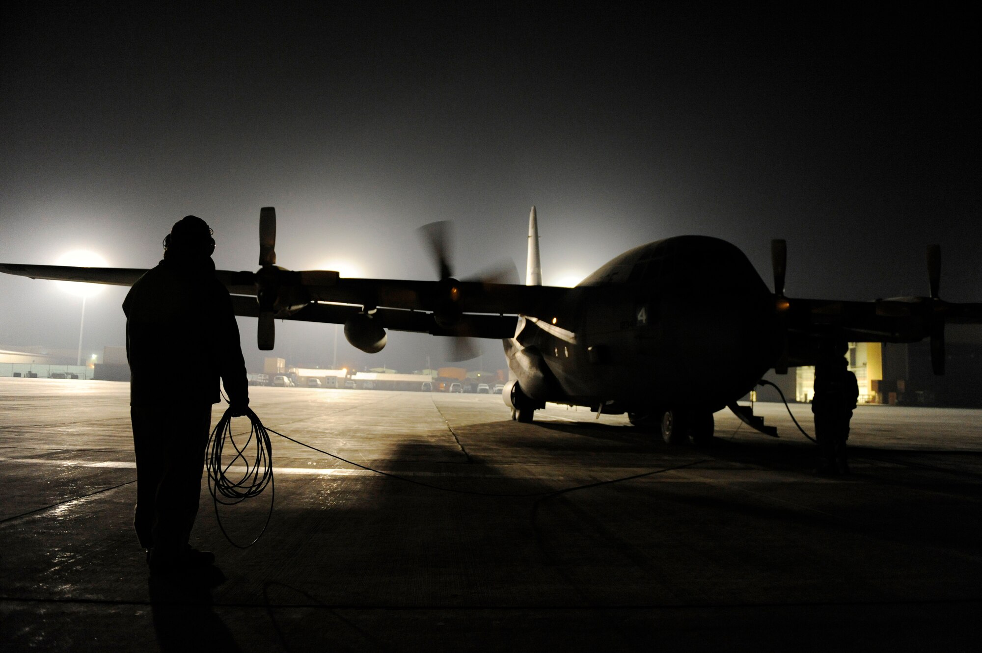 U.S. Air Force Airman 1st Class Cody Bellefleur, 774th Expeditionary Airlift Squadron, ensures the engines of a C-130H Hercules are operating properly during engine startup at Bagram Airfield, Afghanistan, Jan 3, 2011.  C-130s are able to land on runways that many other cargo aircraft are unable to, making them invaluable when moving passengers and cargo.  (U.S. Air Force Photo/Staff Sgt. Eric Harris) (RELEASED)
