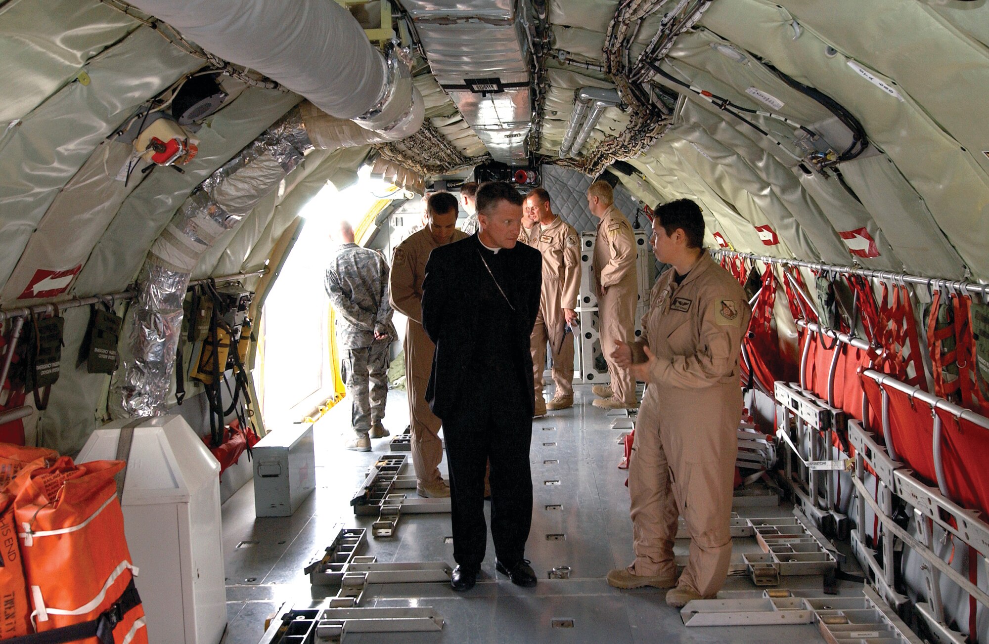 Archbishop Timothy P. Broglio gets a tour of a KC-135 Stratotanker, Dec. 24. Archbishop Broglio was here to celebrate the Christmas Eve Mass for military members on base during the holiday season.    (U.S. Air Force photo/Staff Sergeant Liliana Moreno) 