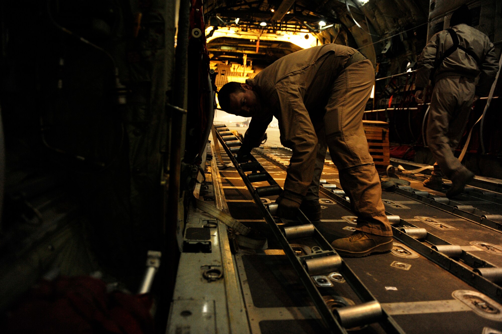 U.S. Air Force Staff Sgt. Chris Patton, 774th Expeditionary Airlift Squadron, prepares a C-130H Hercules to receive cargo at Bagram Airfield, Afghanistan, before a mission to deliver supplies in support of Operation Enduring Freedom, Jan 2, 2011.  C-130 aircrews deliver supplies by air to reduce the number of ground convoys that are at risk.  (U.S. Air Force Photo by Staff Sgt. Eric Harris) 