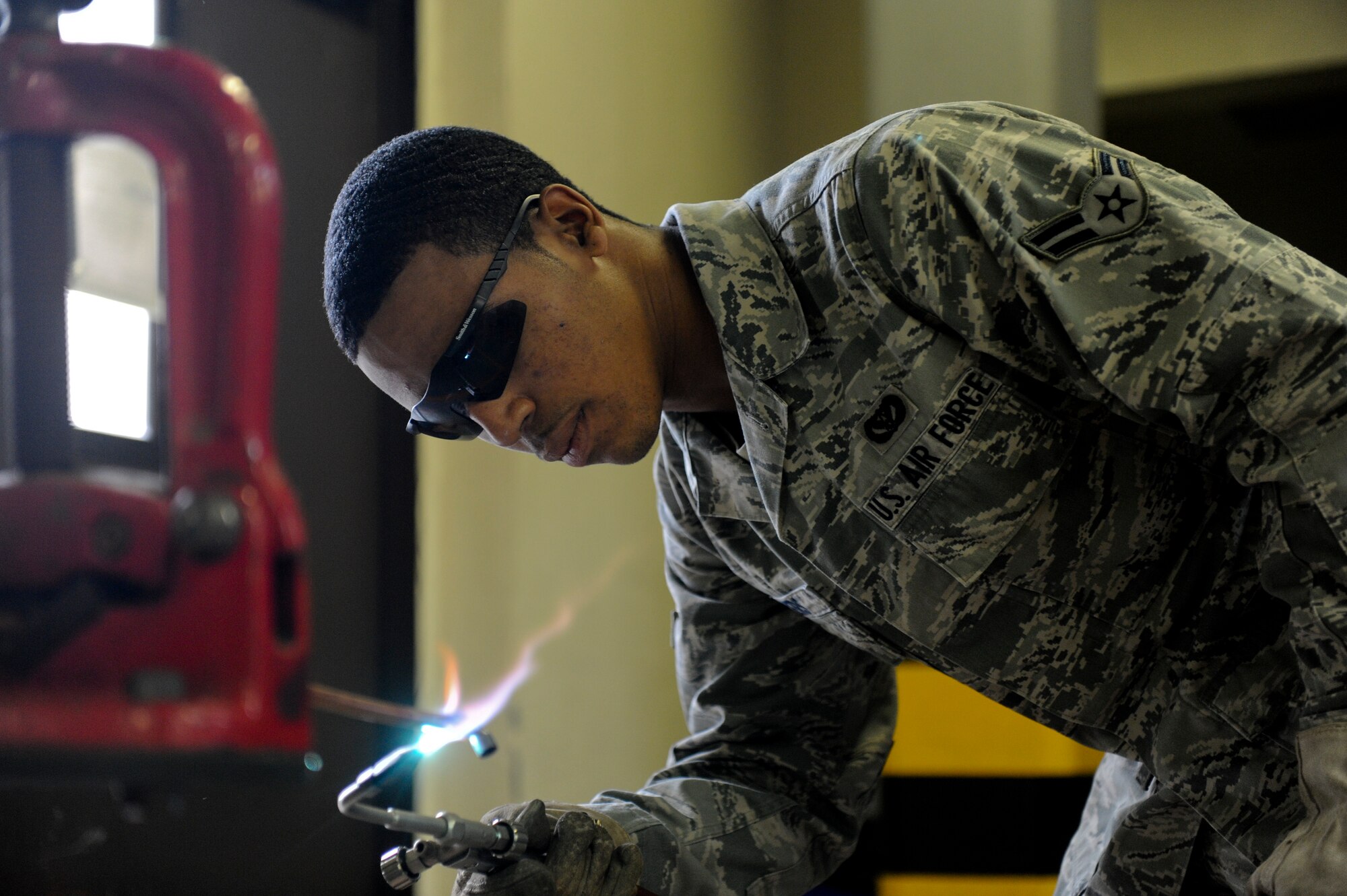 Airman 1st Class Terence Myers, a member of the 18th Civil Engineer Squadron’s Operations Flight, brazes a copper bypass-line that will be installed into a liquid chiller at the Navy communication facility, Jan 10. The Operations Flight was recently awarded the 2010 Major General Clifton D. Wright Award for their outstanding accomplishments in 2010. (U.S. Air Force photo/Staff Sgt. Jonathan Steffen)