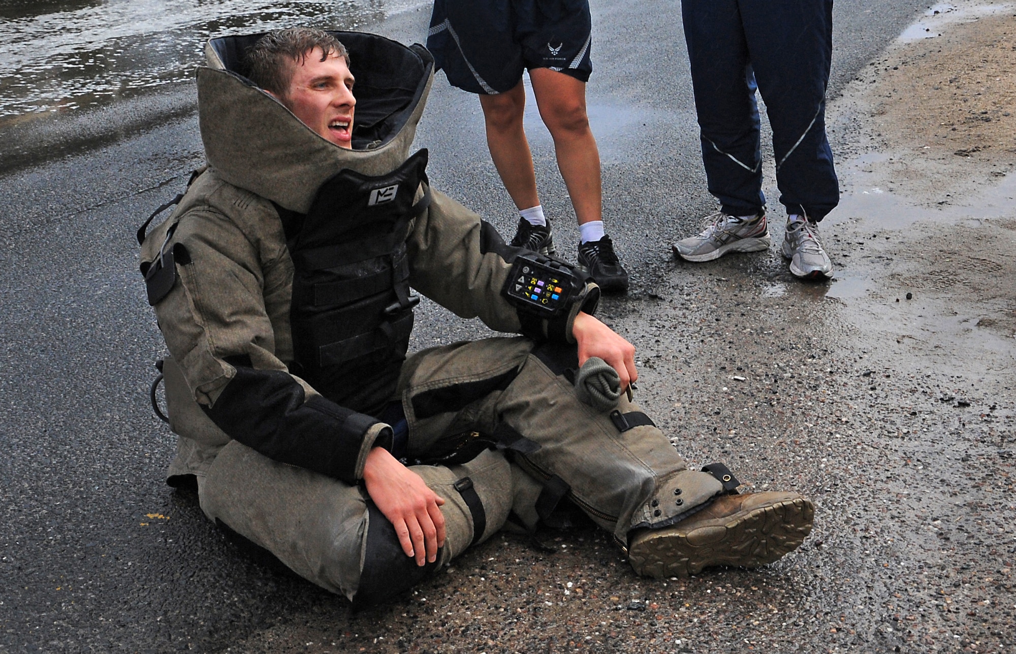 Staff Sgt. Robin Cunningham rests in his bomb suit after participating in the explosive ordnance disposal fun run Dec. 31. The fun run was part of a fundraiser and to raise awareness for EOD Wounded Warrior, Hope for the Warriors and the EOD Memorial. Sergeant Cunningham is an EOD journeyman with the 386th Expeditionary Civil Engineer Squadron. (U.S. Air Force photo by Senior Airman Cynthia Spalding)
