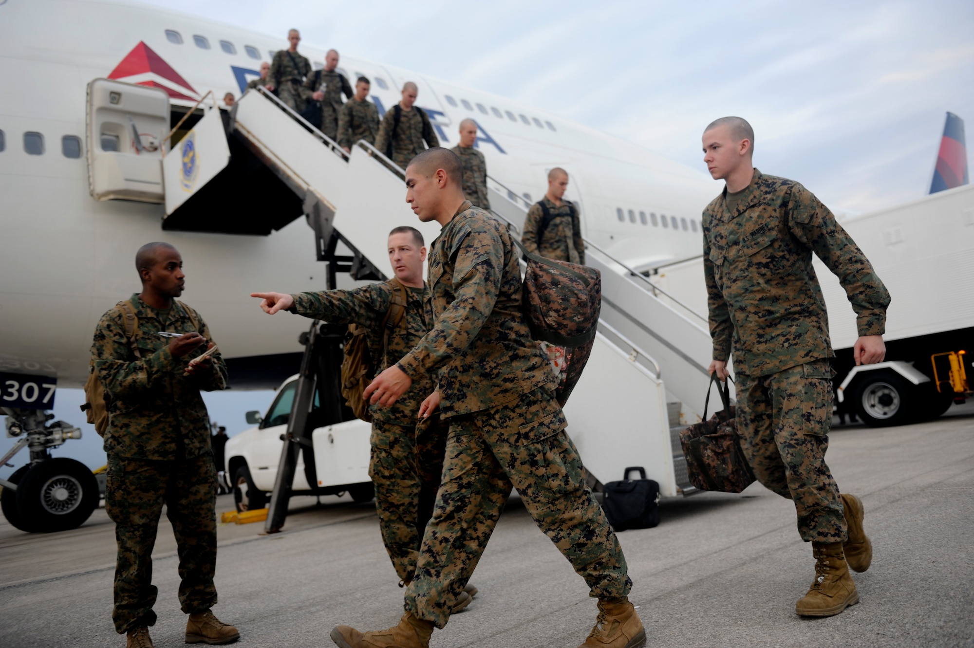 Marines from the 3rd Marine Expeditionary Force unload from a Boeing 747 on Kadena's flight line Jan. 6. The Air Force provided the 3,000 Marines from the 3rd MEF with lodging, dining facilities, transportation and other services, in support of their movement through Kadena's Air Mobility Command Passenger Terminal. (U.S. Air Force photo/Staff Sgt. Jonathan Steffen)