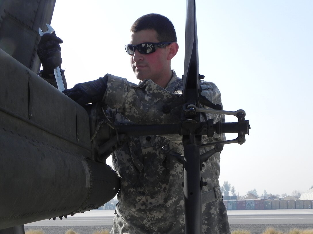Army Spc. Carlos Mendez performs routine maintenance on an OH-58D Kiowa helicopter at Forward Operating Base Fenty, Afghanistan, Jan. 5, 2011. U.S. Army photo by Spc. Kam Gerohimos