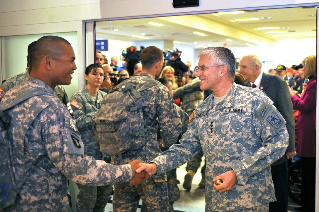 U.S. Army Chief of Staff Gen. George W. Casey Jr. greets a soldier returning from deployment at Dallas/Fort Worth International Airport in Dallas, Jan. 11, 2011. 