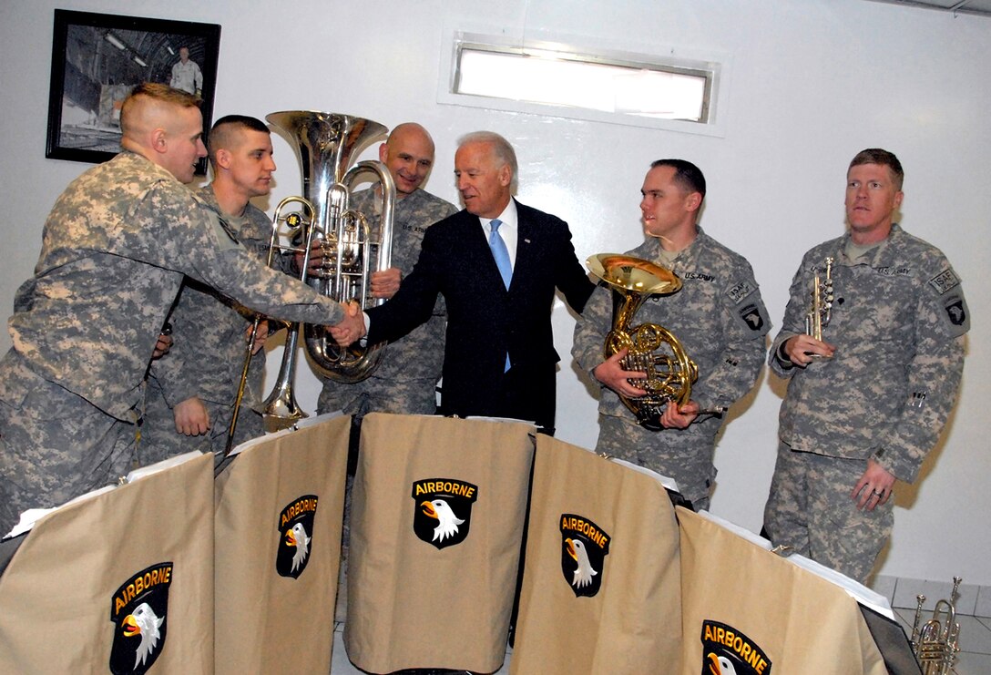 U.S. Vice President Joe Biden thanks members of the 101st Division Band brass quintet for their performance during his visit to Bagram Airfield, Afghanistan, Jan 12, 2011.