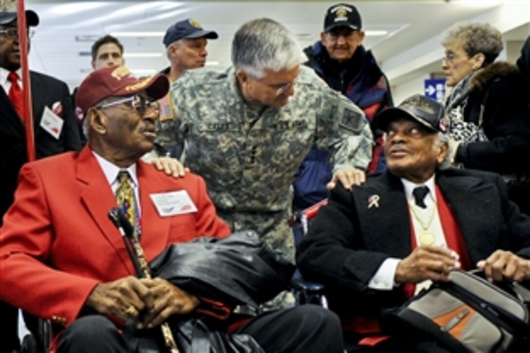 Army Chief of Staff Gen. George W. Casey Jr. talks with members of the Tuskegee Airmen at the Dallas/Fort Worth International Airport in Dallas, Jan. 11, 2011. The airmen and hundreds of volunteers from the "Welcome Home a Hero" program greeted troops and participated in a ceremony marking the one-millionth soldier returning home for rest and recuperation from Iraq and Afghanistan.  