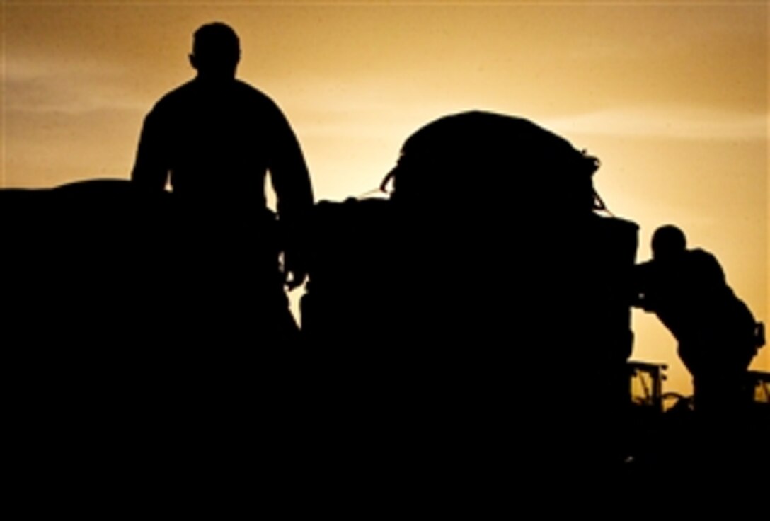 U.S. Marines move containers filled with water on Camp Leatherneck, Afghanistan, Jan. 5, 2011. The Marines are parachute riggers assigned to the 1st Marine Logistics Group, Headquarters and Service Company, 1st Marine Logistics Group. The water was air dropped in Helmand province to Marines assigned to the 1st Marine Division's 2nd Battalion, 1st Marine Regiment.