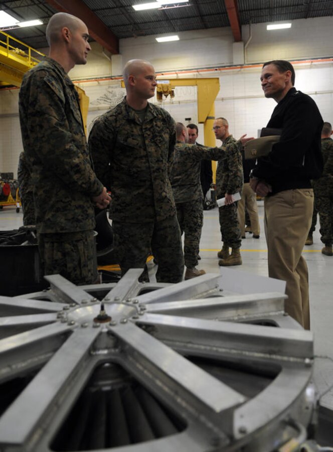 Rear Adm. Tim Matthews, Naval Air Systems Command logistics commander speaks::r::::n::with Sgt. Richard Davis, Marine Aviation Logistics Squadron 13 collateral duty inspector::r::::n::and Sgt. Brain Row, MALS-13 mechanic, on the latest discoveries in their shop. MALS-::r::::n::13 Marines presented several displays to commanders in the Naval Aviation Enterprise::r::::n::to show them firsthand how maintenance and supply activities have incorporated better::r::::n::business practices into their work centers, Jan.12, 2011. Boots on the ground, an even::r::::n::lasting day or two, not only provides sailors and Marines the opportunity to meet with::r::::n::leadership but also gives leaders a chance to see what issues need to be addressed.