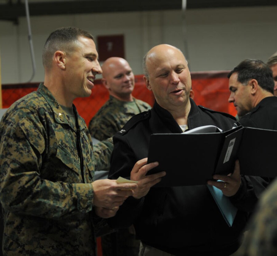 Maj. Leonard Domitrovits, Marine Aviation Logistics Squadron 13 aircraft maintenance::r::::n::officer, discusses matters on the continuous process improvements, or CPI, with Capt.::r::::n::Mike Kelly, Naval Air Forces Commander assistant chief of staff. MALS-13 Marines::r::::n::presented several displays to commanders in the Naval Aviation Enterprise to show::r::::n::them firsthand how maintenance and supply activities have incorporated better business::r::::n::practices into their work centers, Jan.12, 2011. Boots on the ground, an even lasting day::r::::n::or two, not only provides sailors and Marines the opportunity to meet with leadership but::r::::n::also gives leaders a chance to see what issues need to be addressed.