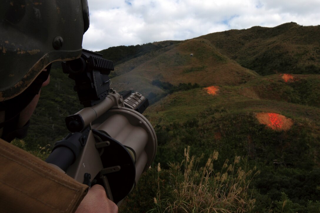 A U.S. Marine Corps Reconnaissance Marine, with Alpha Company, 3rd Reconnaissance Battalion, 3rd Marine Division fires the M32A1 multi-shot grenade launcher on a range on Camp Hansen Jan. 13.