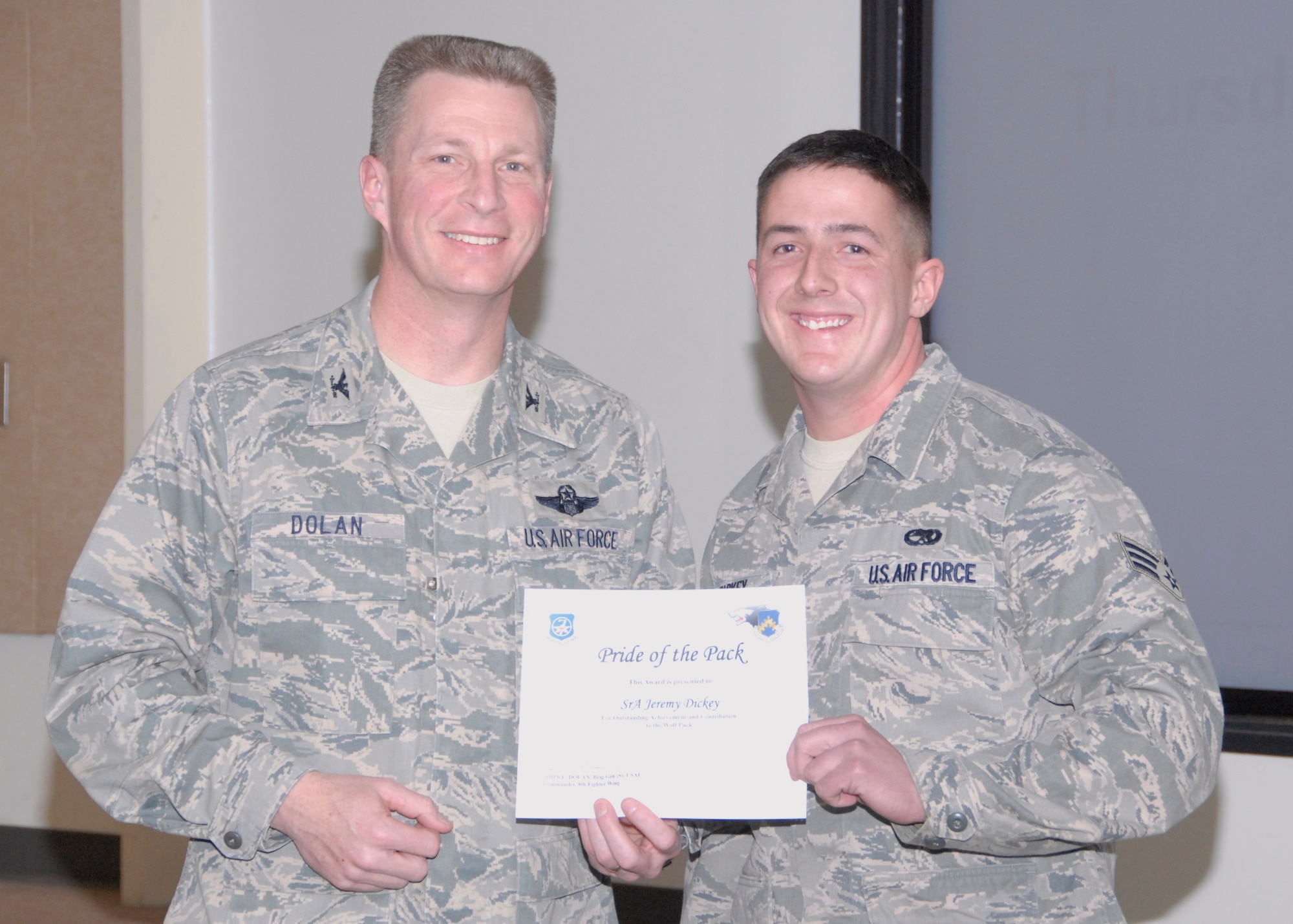 KUNSAN AIR BASE, Republic of Korea -- Col. John Dolan, 8th Fighter Wing commander, presents Senior Airman Jeremy Dickey, 8th Aircraft Maintenance Squadron, with a Pride of the Pack award Jan. 13. (U.S. Air Force photo/Capt. Sheryll Klinkel) 