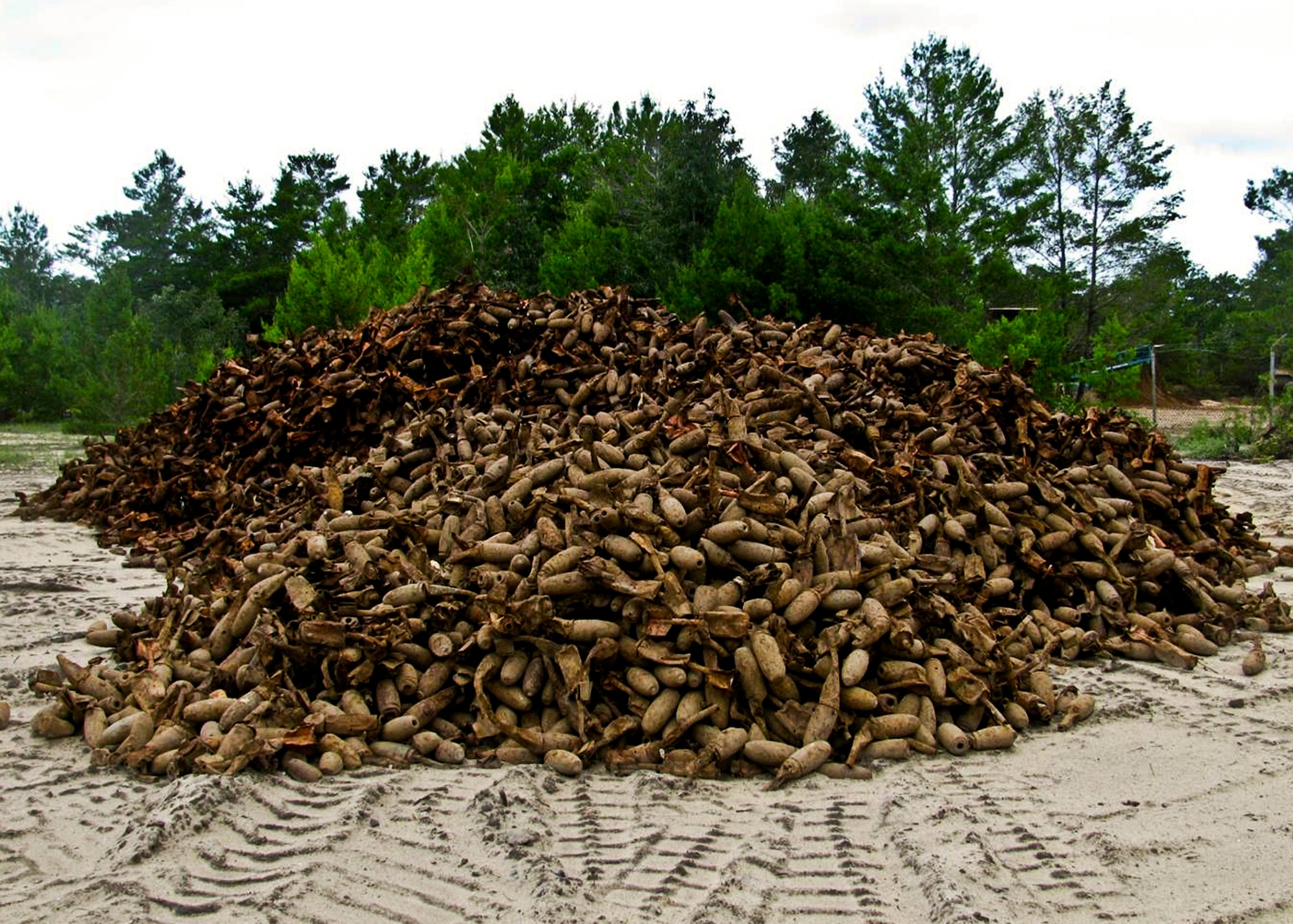 Discarded miniature practice bombs from Eglin Air Force Base, Fla., are piled at a commercial shredding facility near the base.  The bombs will be fed into a shredder and the shredded material then will be recycled.  To date, more than seven million pounds of range debris metal have been recycled, saving the government millions of dollars. (Courtesy photo)