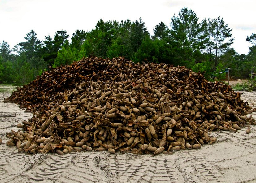 Discarded miniature practice bombs from Eglin Air Force Base, Fla., are piled at a commercial shredding facility near the base.  The bombs will be fed into a shredder and the shredded material then will be recycled.  To date, more than seven million pounds of range debris metal have been recycled, saving the government millions of dollars. (Courtesy photo)