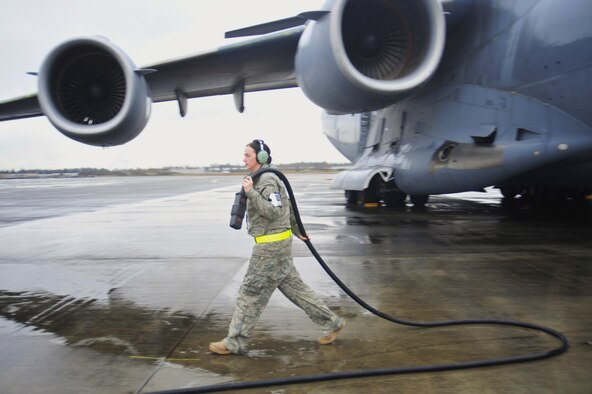 Staff Sgt. Amaya Talley, 62nd Aircraft Maintenance Squadron silver aircraft maintenance unit crew chief, retrieves a power chord on a generator Jan. 13, 2010, at Joint Base Lewis-McChord, Wash. (U.S. Air Force Photo/Airman Leah Young) 