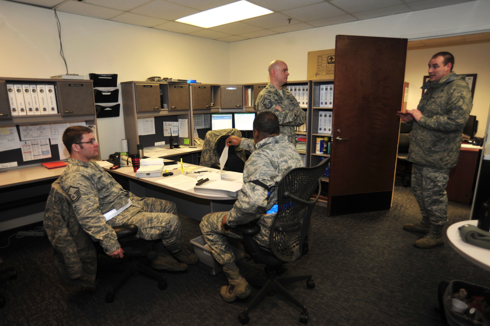 Airmen assigned to the 62nd Aircraft Maintenance Squadron discuss aircraft repairs and flight plans Jan. 13 at Joint Base Lewis-McChord, Wash. (U.S. Air Force photo/Airman Leah Young)