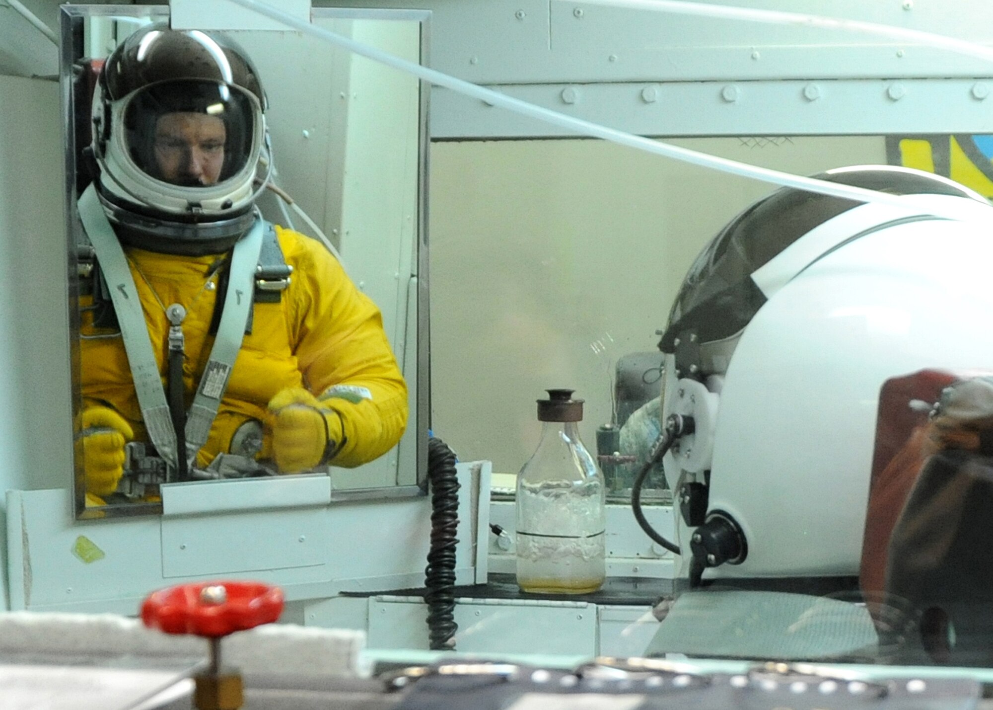 Gen. William M. Fraser III, commander of Air Combat Command, looks in the mirror as he tenses up while ascending in the high-altitude chamber at Beale Air Force Base, Calif., Jan. 10. The ascent to 70,000 feet causes the pressure suit to inflate, keeping the body at an altitude of 35,000 feet. (U.S. Air Force photo/9th Reconnaissance Wing Public Affairs)