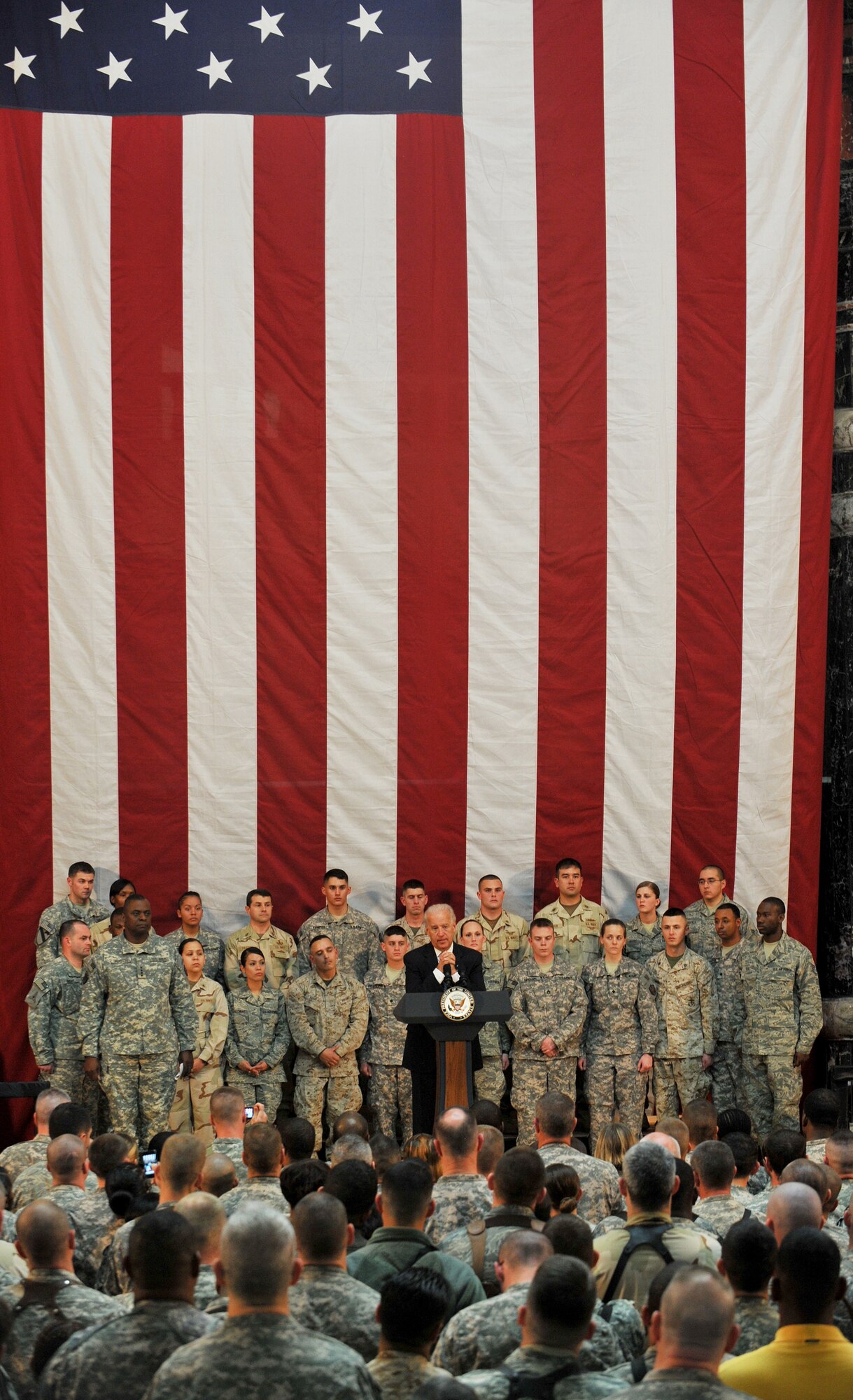 Vice President Joe Biden speaks to a crowd of more than 200 servicemembers and civilians about the partnership with the Iraqis and his appreciation for military members and their families Jan. 13 on Camp Victory, Iraq. The vice president said he brought a word of thanks from the American people to the military members in the fight for Operation New Dawn. (U.S. Air Force photo by Senior Airman Andrew Lee)